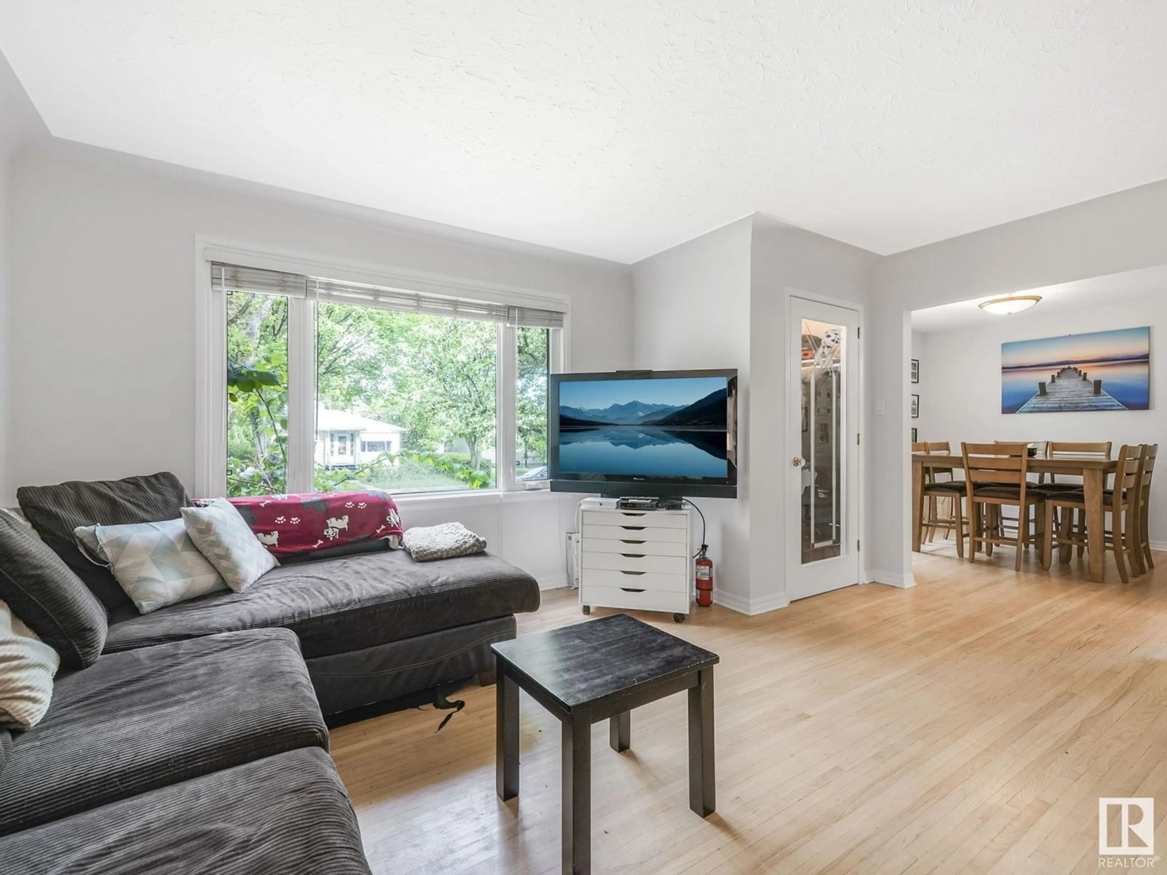 Living room with furniture, wood/laminate floor for 11514 122 ST, Edmonton Alberta T5M0C1