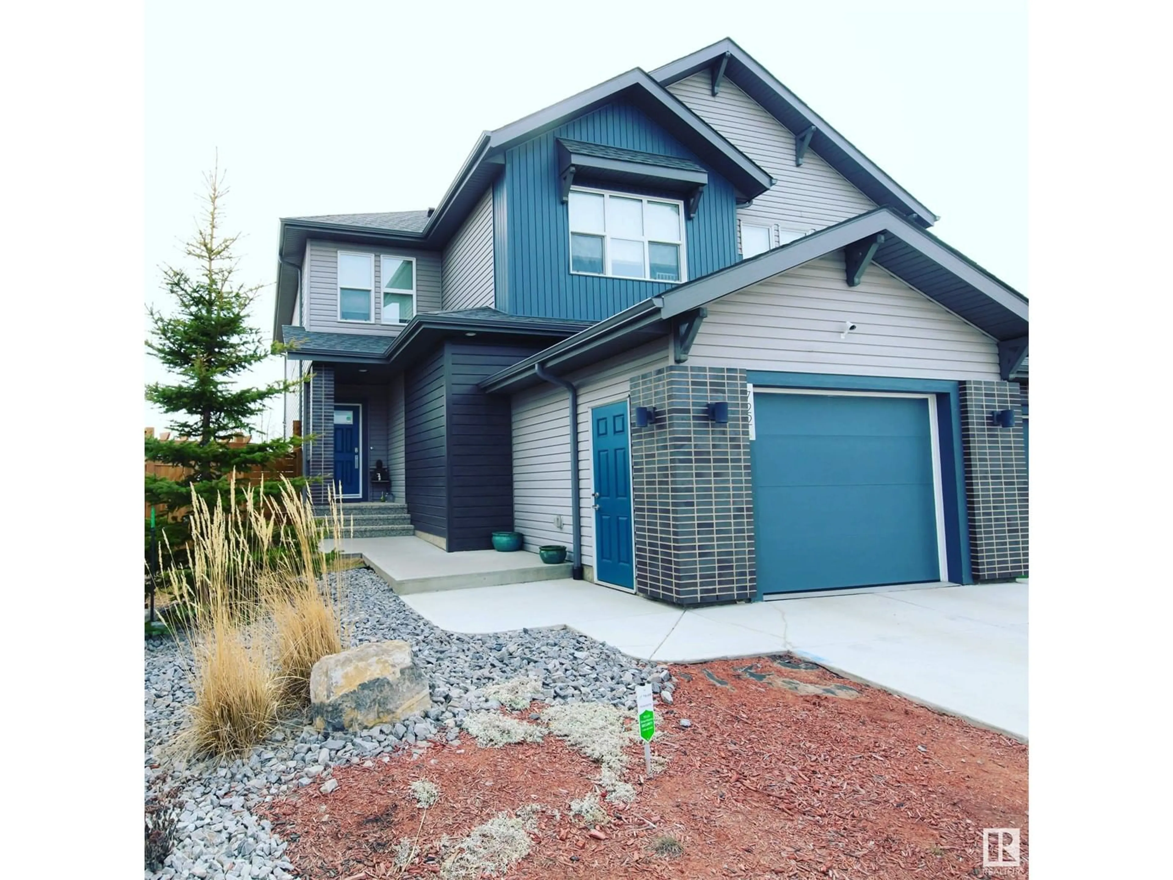Home with vinyl exterior material, street for 722 CHARLESWORTH WY, Edmonton Alberta T6X2E9