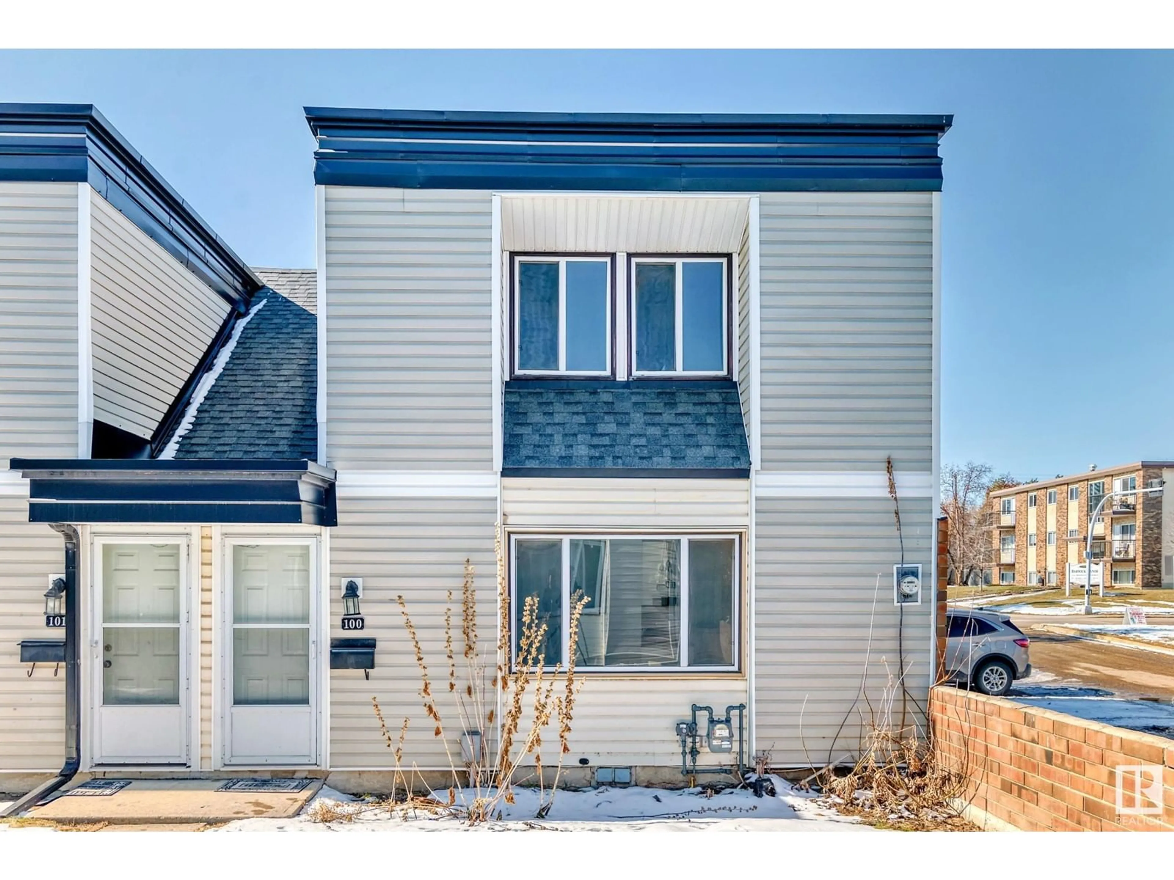 Home with vinyl exterior material, street for #100 - 11421 34 ST, Edmonton Alberta T5W5J7
