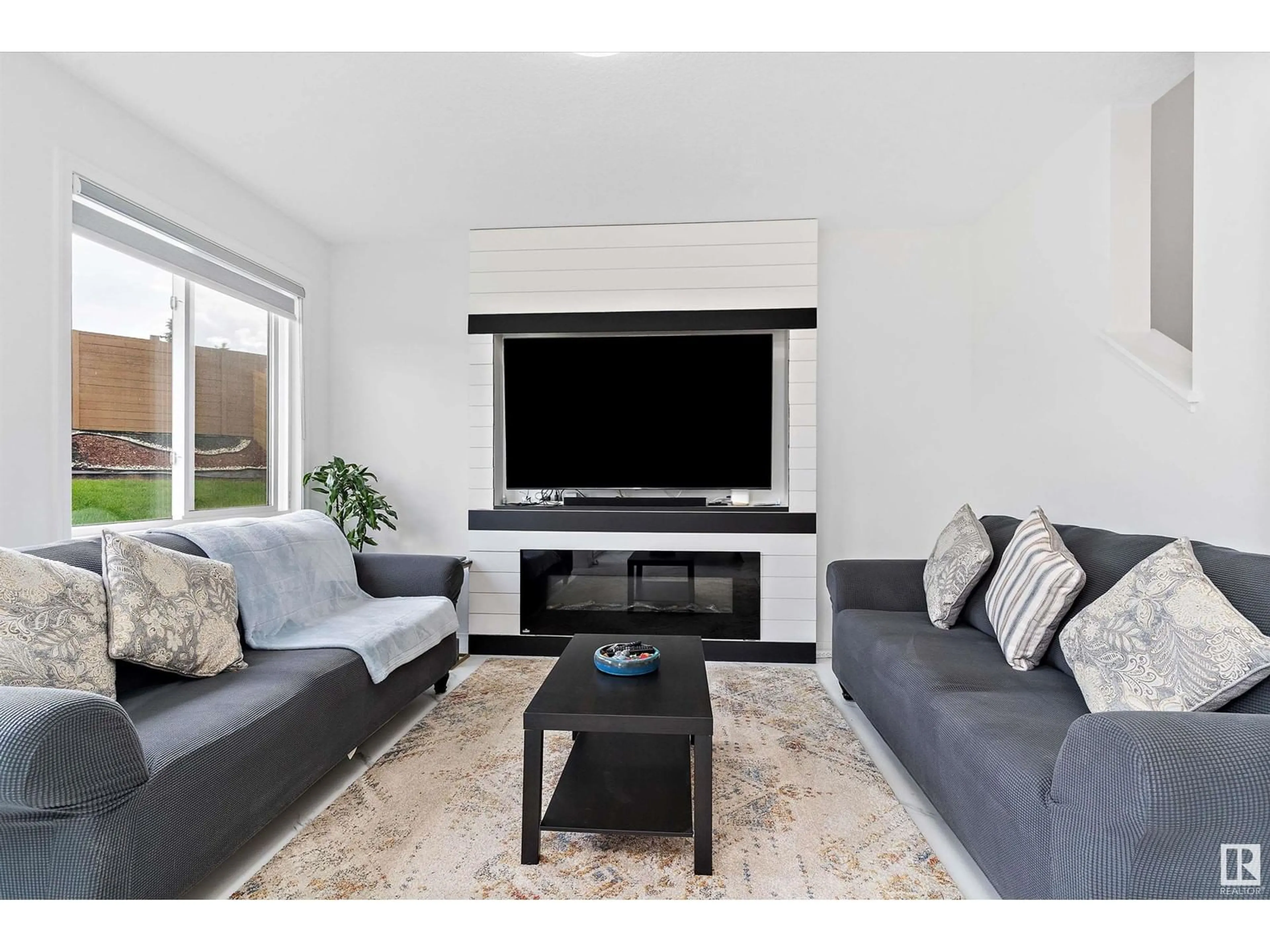 Living room with furniture, wood/laminate floor for 3503 8 AV, Edmonton Alberta T6X2Z1
