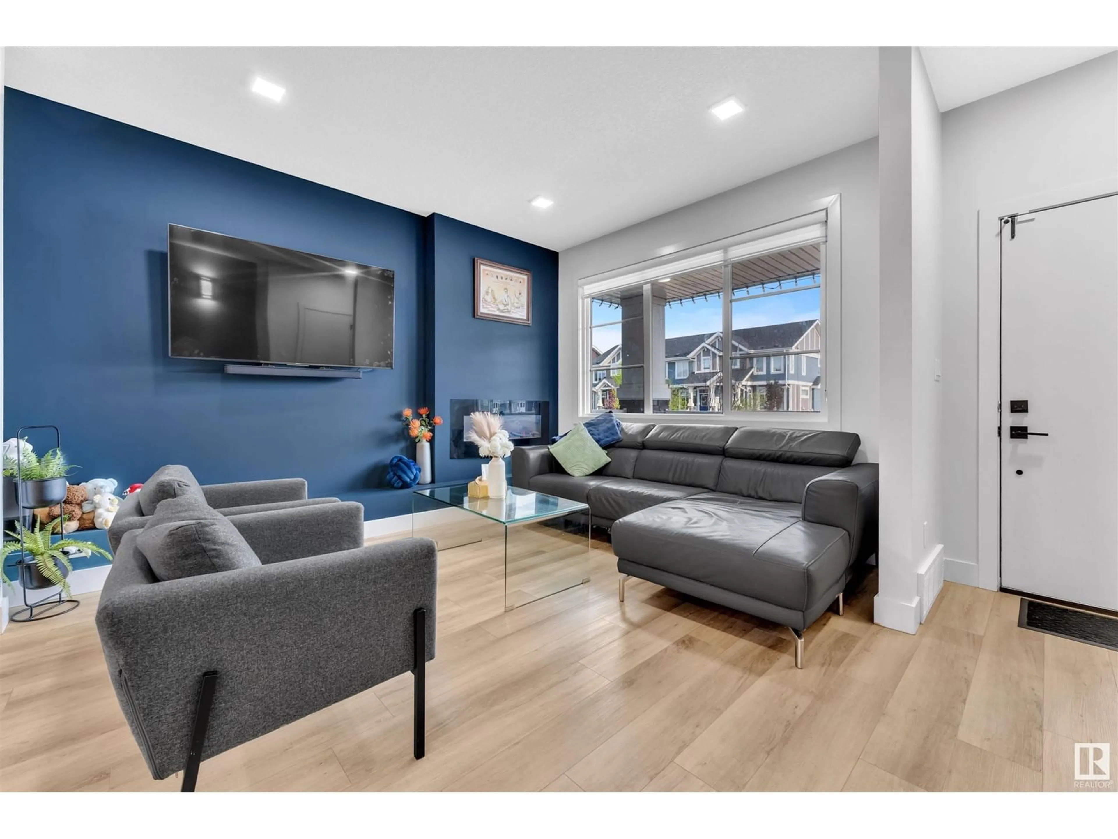 Living room with furniture, wood/laminate floor for 576 GLENRIDDING RAVINE DR, Edmonton Alberta T6W4P1