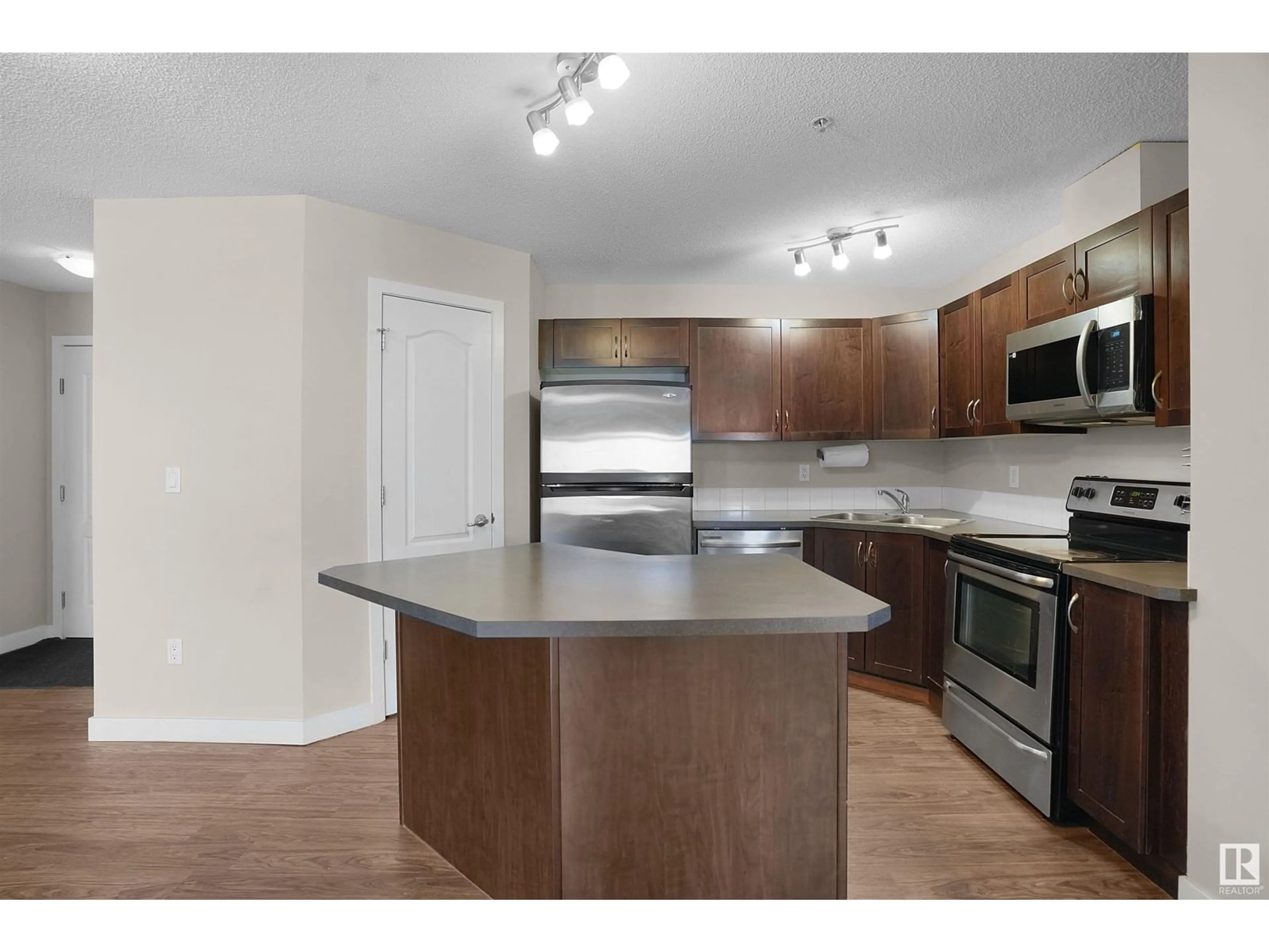 Open concept kitchen, wood/laminate floor for #218 - 392 SILVER BERRY RD, Edmonton Alberta T6T0H1