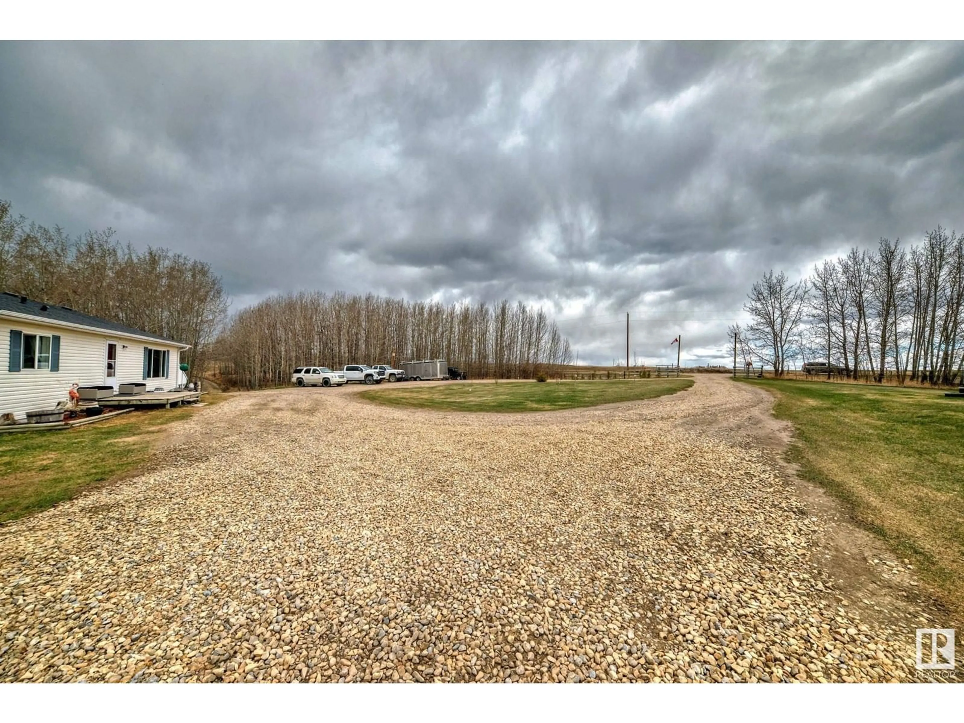 A pic from outside/outdoor area/front of a property/back of a property/a pic from drone, water/lake/river/ocean view for 25113 TWP RD 272, Rural Rockyview County Alberta T4B2A3