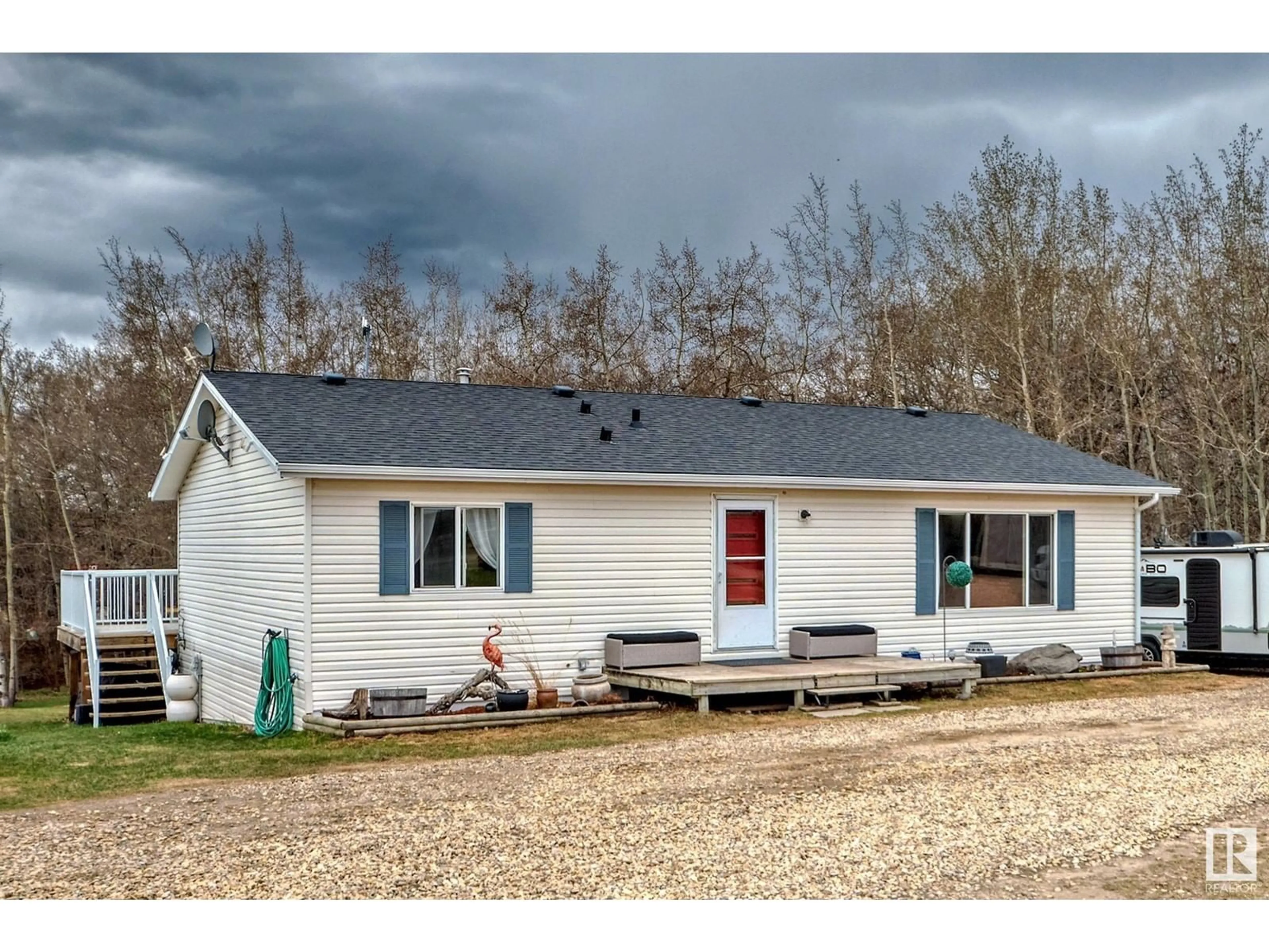 Home with vinyl exterior material, street for 25113 TWP RD 272, Rural Rockyview County Alberta T4B2A3