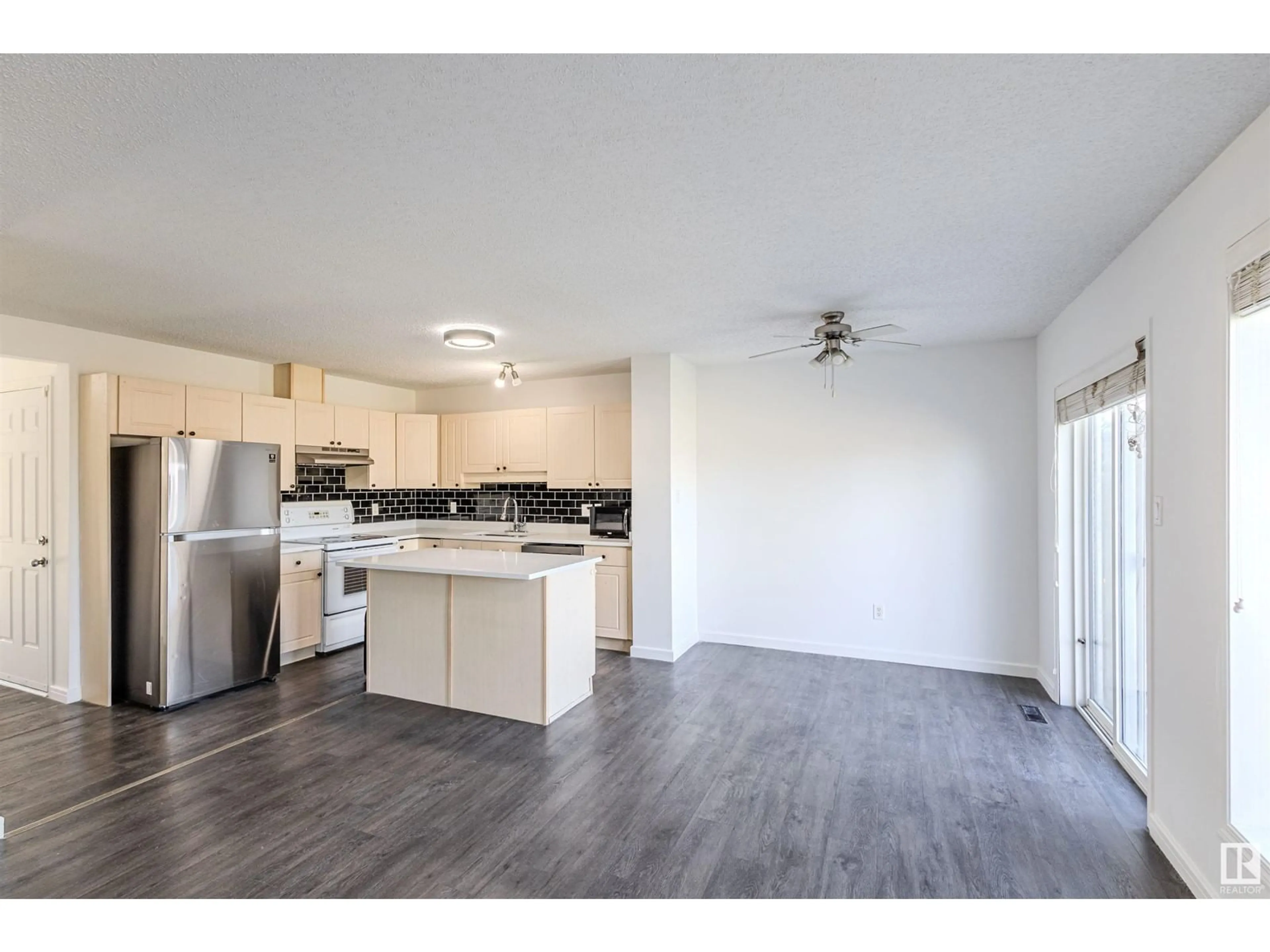 Open concept kitchen, wood/laminate floor for 2832 26 STREET, Edmonton Alberta T6T2A2