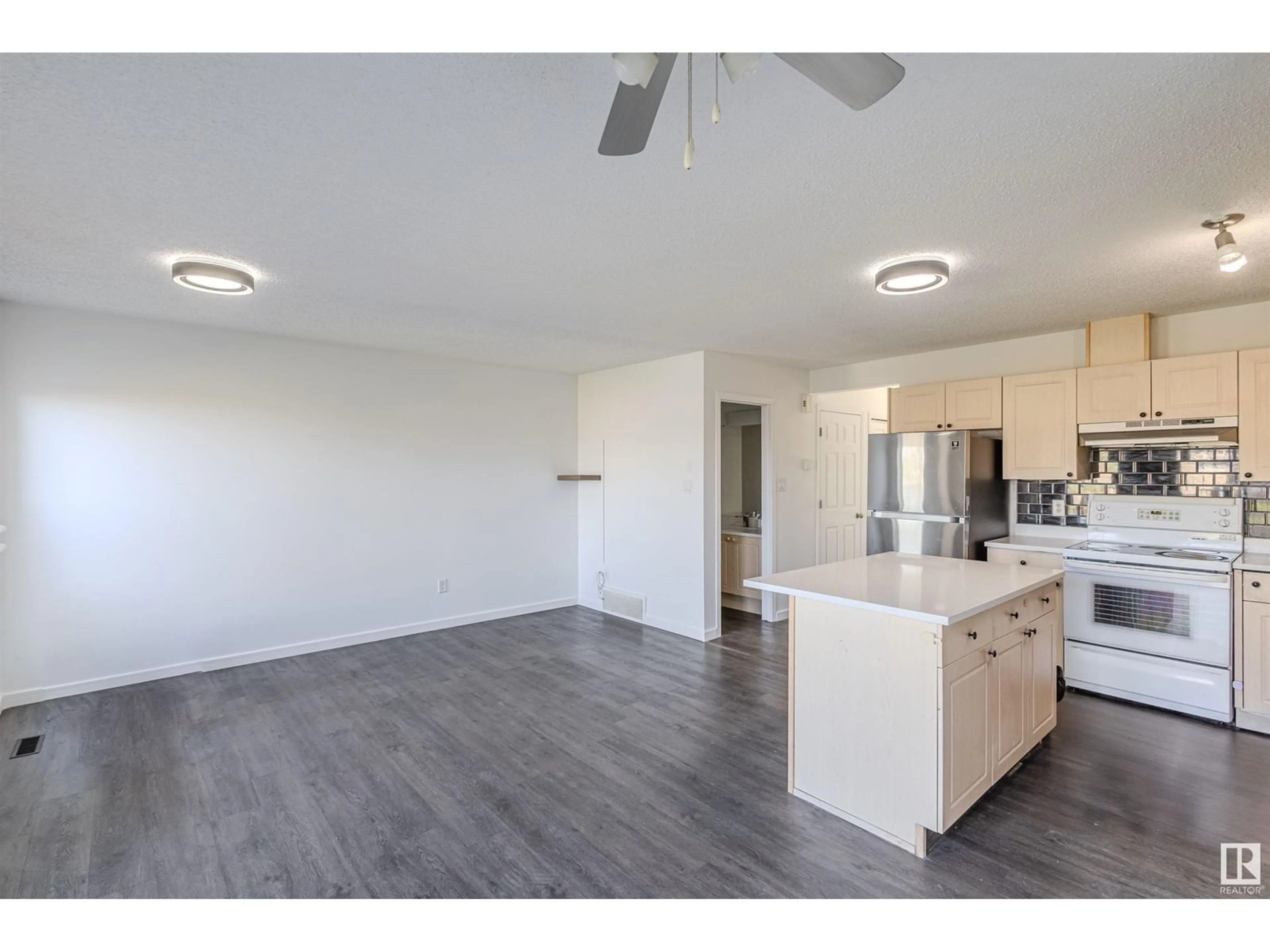 Open concept kitchen, wood/laminate floor for 2832 26 STREET, Edmonton Alberta T6T2A2