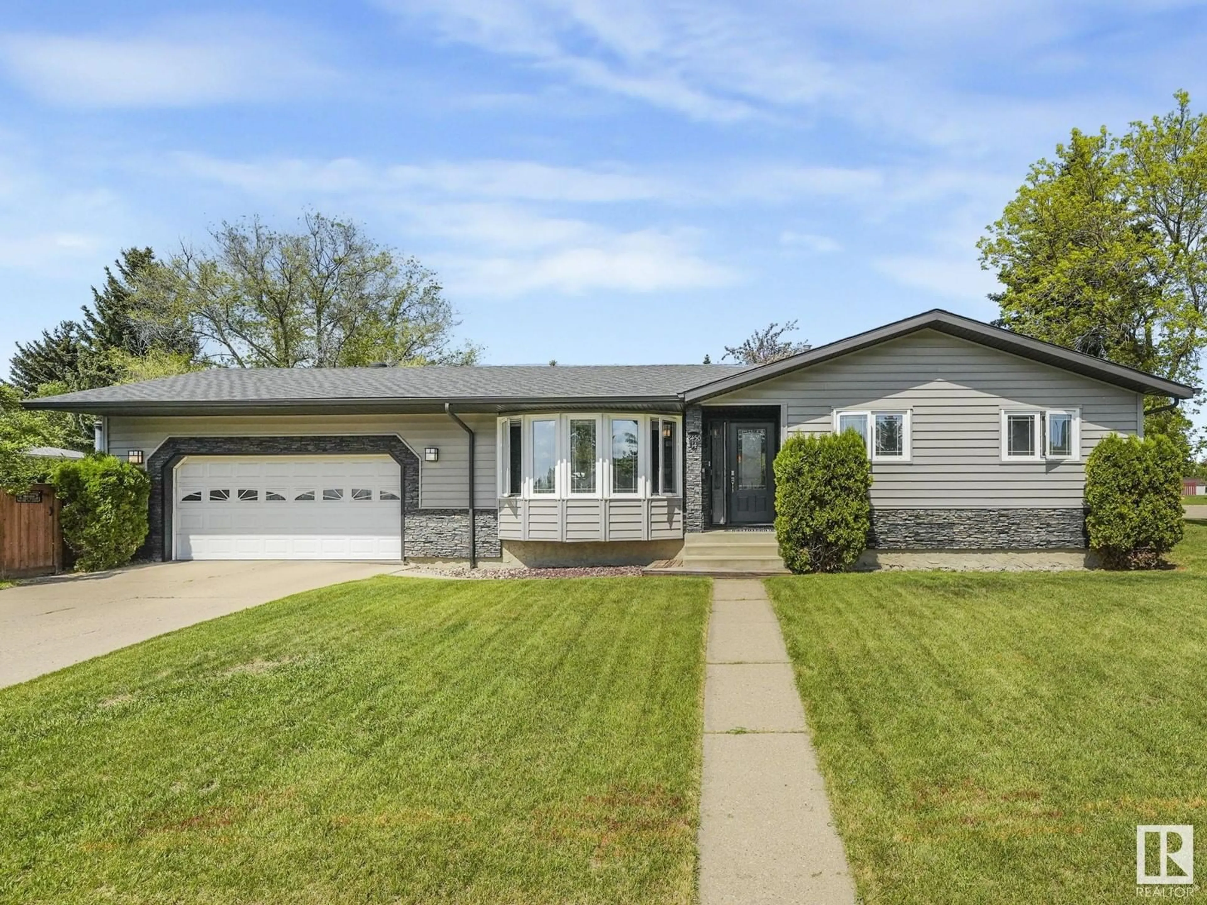 Home with vinyl exterior material, street for 8450 14 AV, Edmonton Alberta T6K1X4