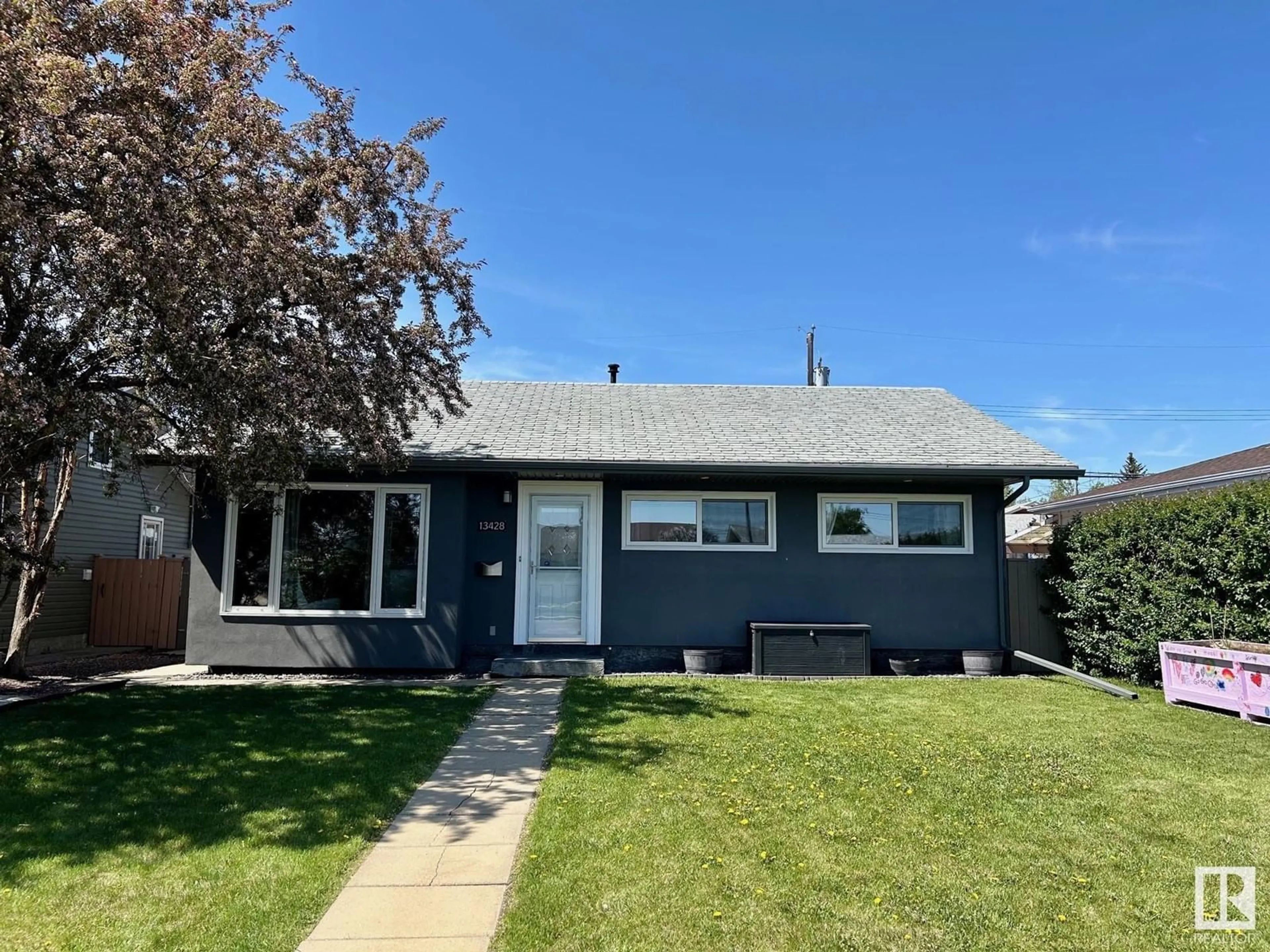 Home with vinyl exterior material, street for 13428 135 ST, Edmonton Alberta T5L1Y9