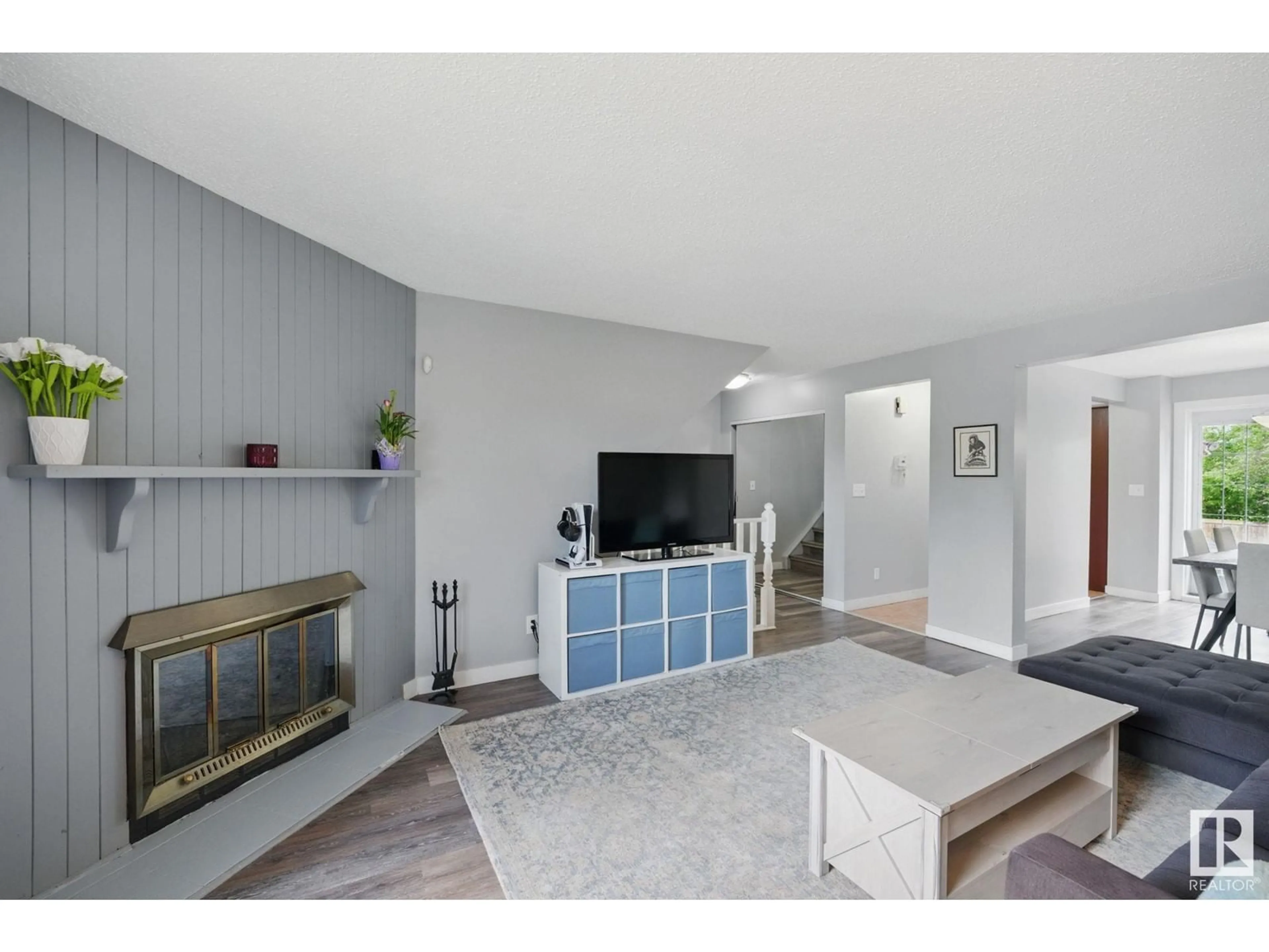 Living room with furniture, wood/laminate floor for NW - 10104A 28A AV, Edmonton Alberta T6J4J6