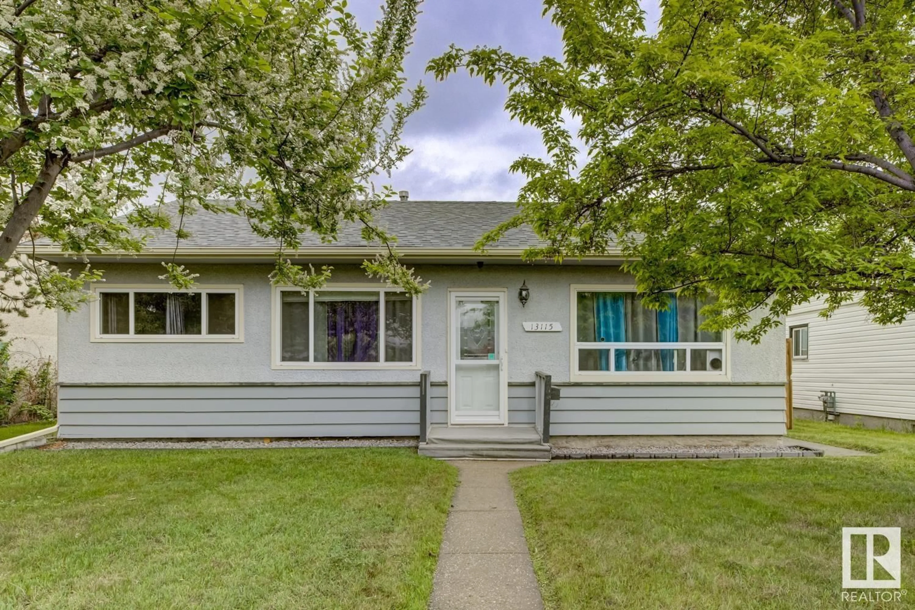 Home with vinyl exterior material, street for 13115 133 ST NW, Edmonton Alberta T5L1T2