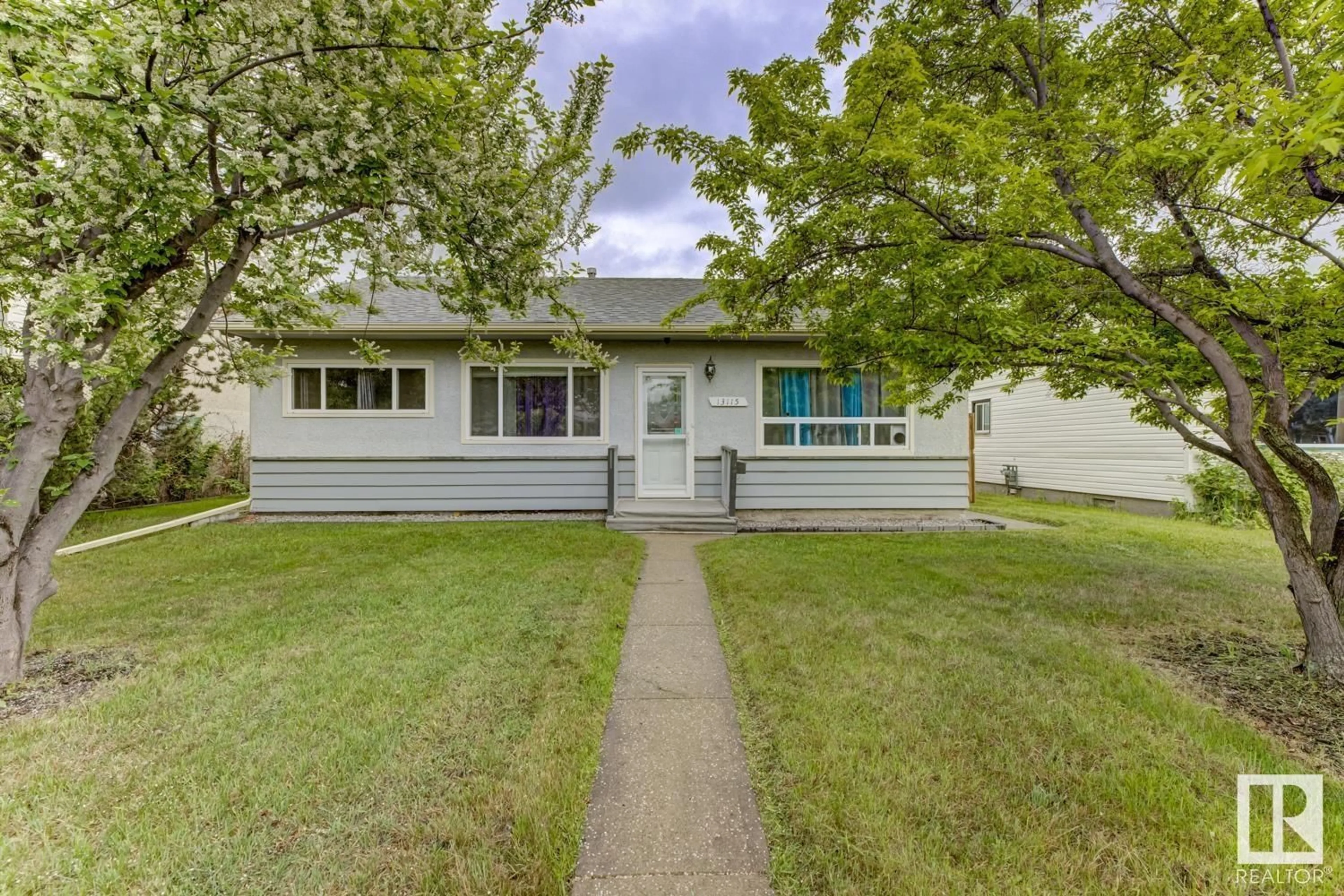 Home with vinyl exterior material, street for 13115 133 ST NW, Edmonton Alberta T5L1T2