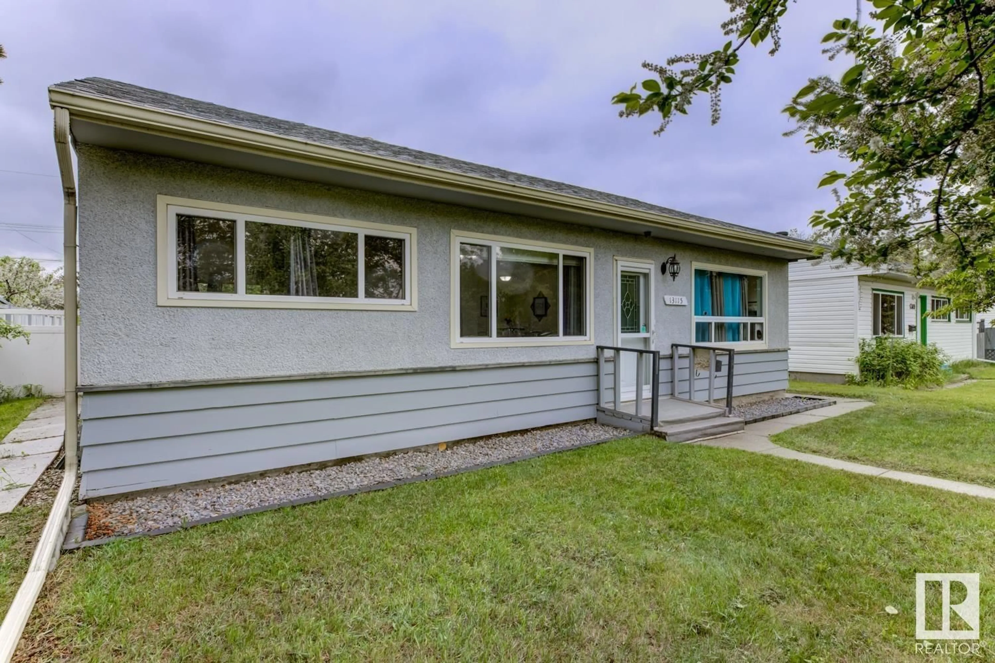 Home with vinyl exterior material, street for 13115 133 ST NW, Edmonton Alberta T5L1T2