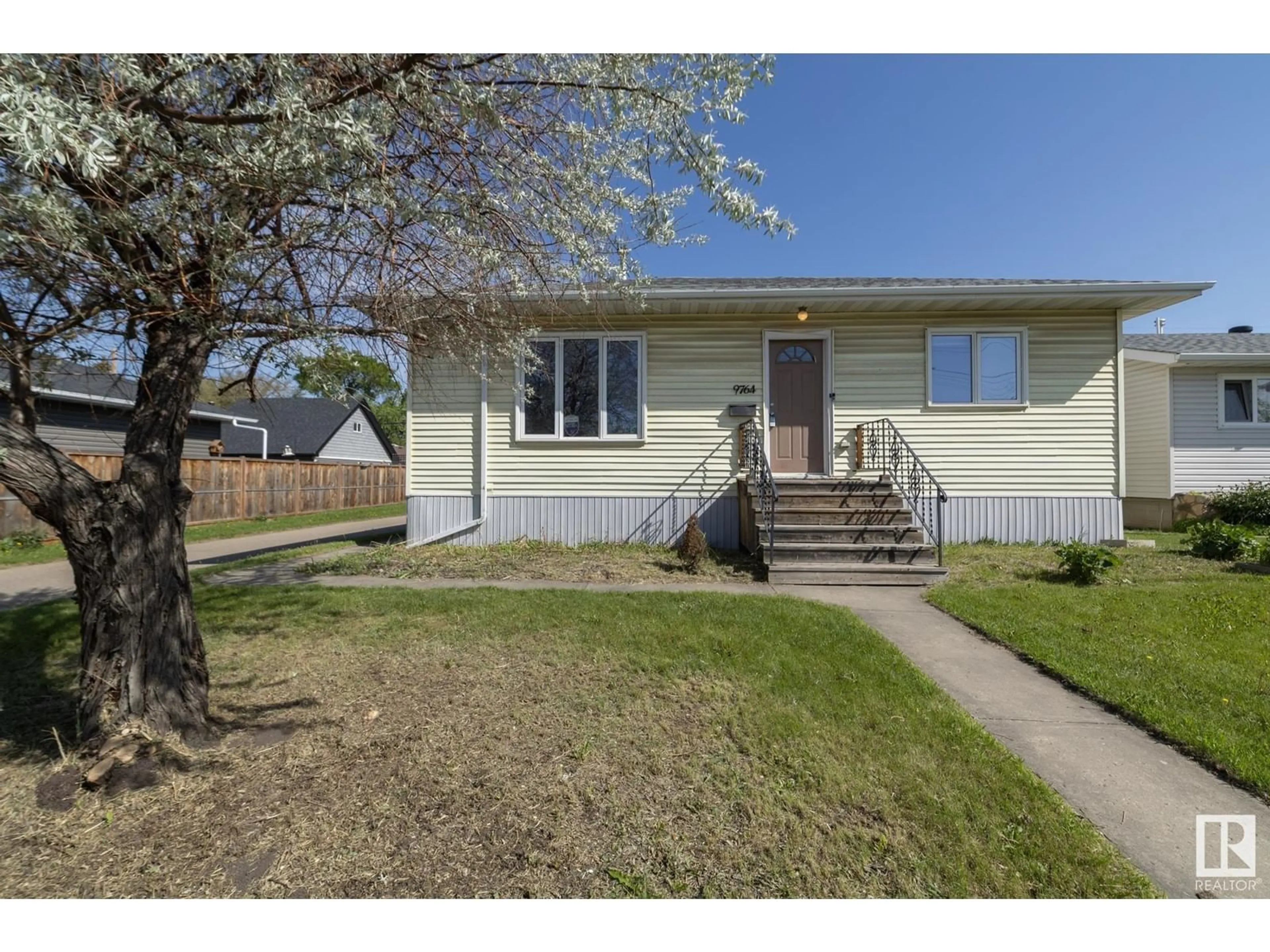 Home with vinyl exterior material, street for 9764 63 AV, Edmonton Alberta T6E0G6