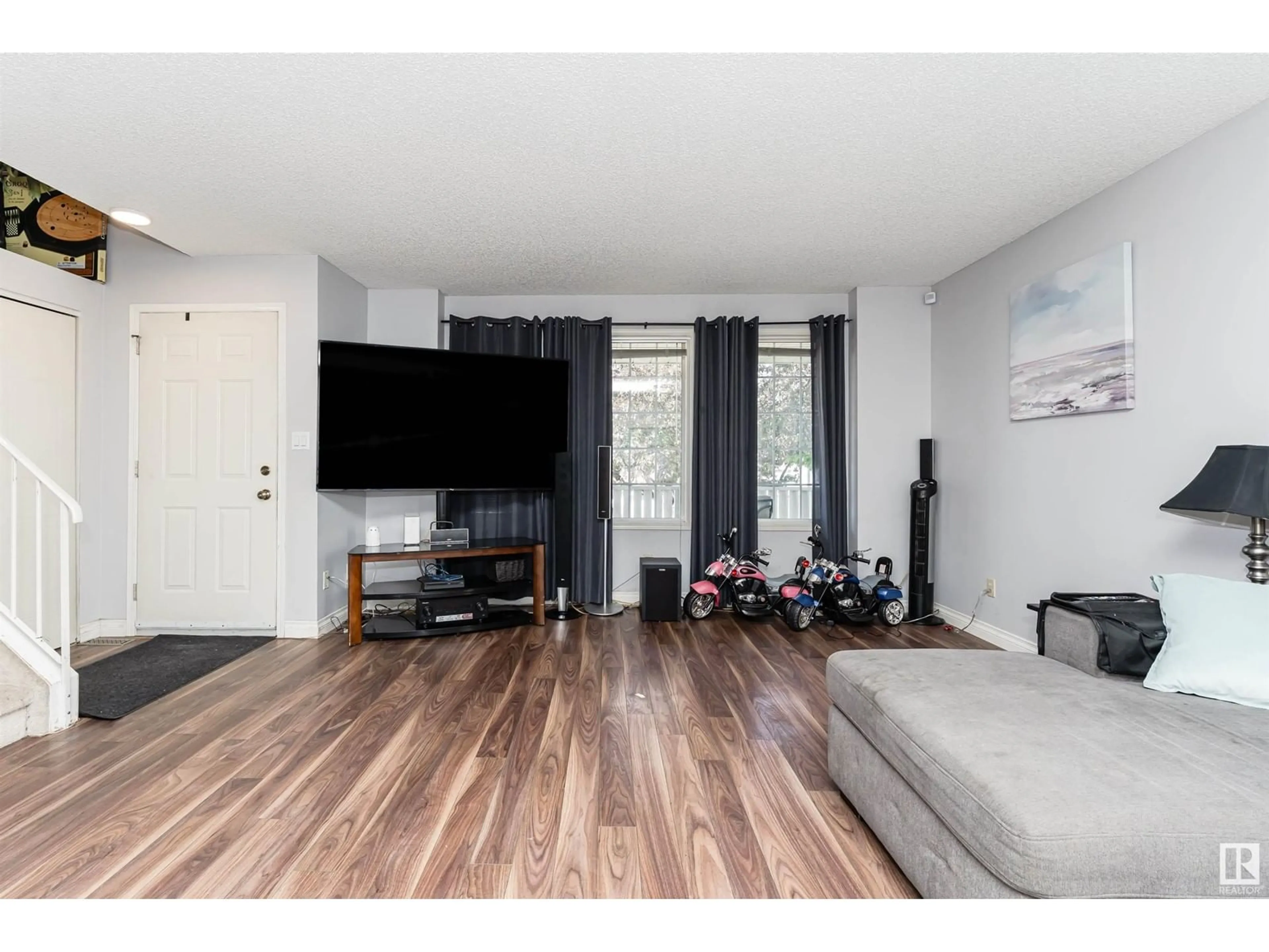 Living room with furniture, wood/laminate floor for 1564 JARVIS CR, Edmonton Alberta T6L6S3
