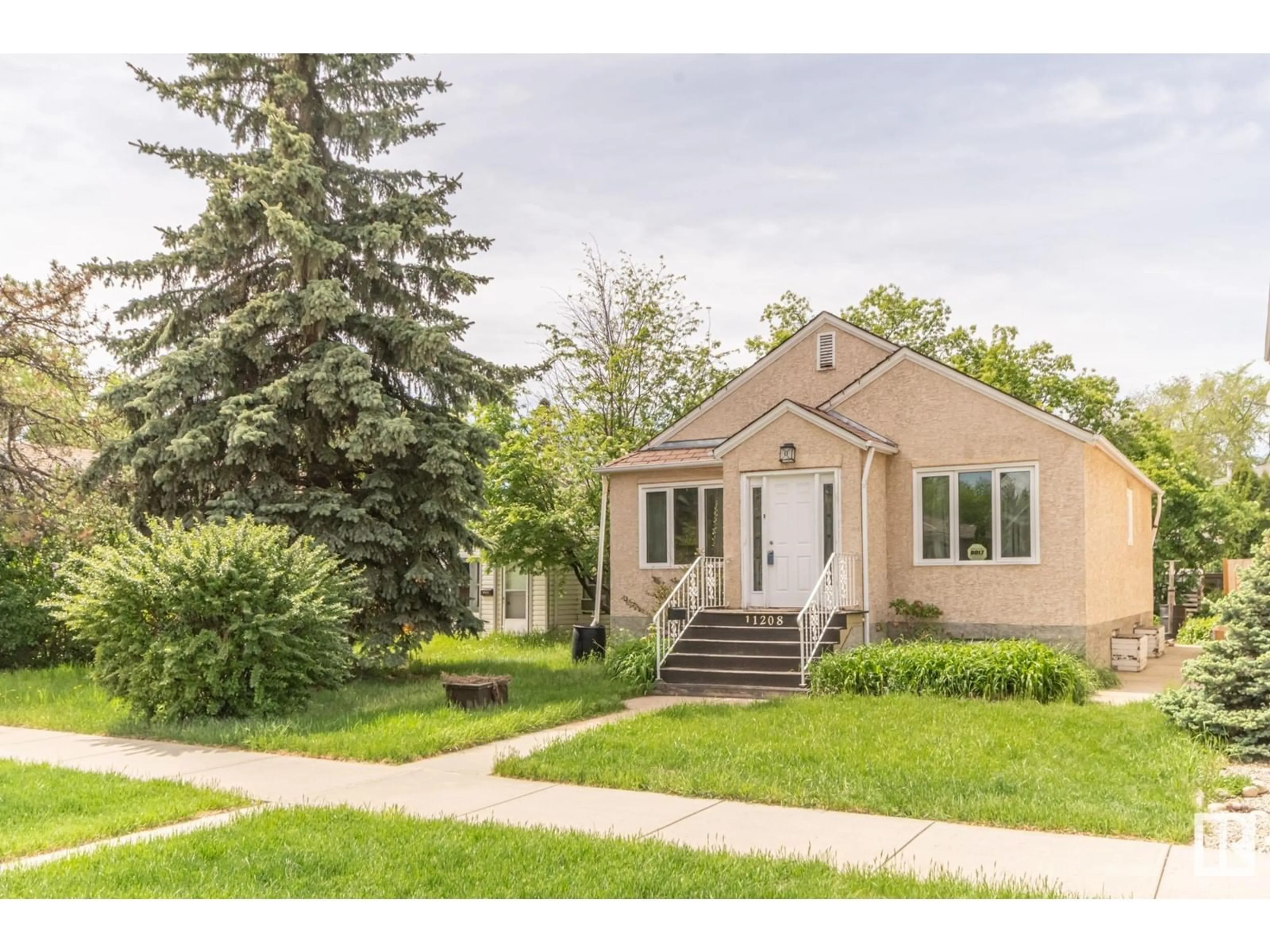 Home with vinyl exterior material, street for NW - 11209 79 ST, Edmonton Alberta T5B2J7