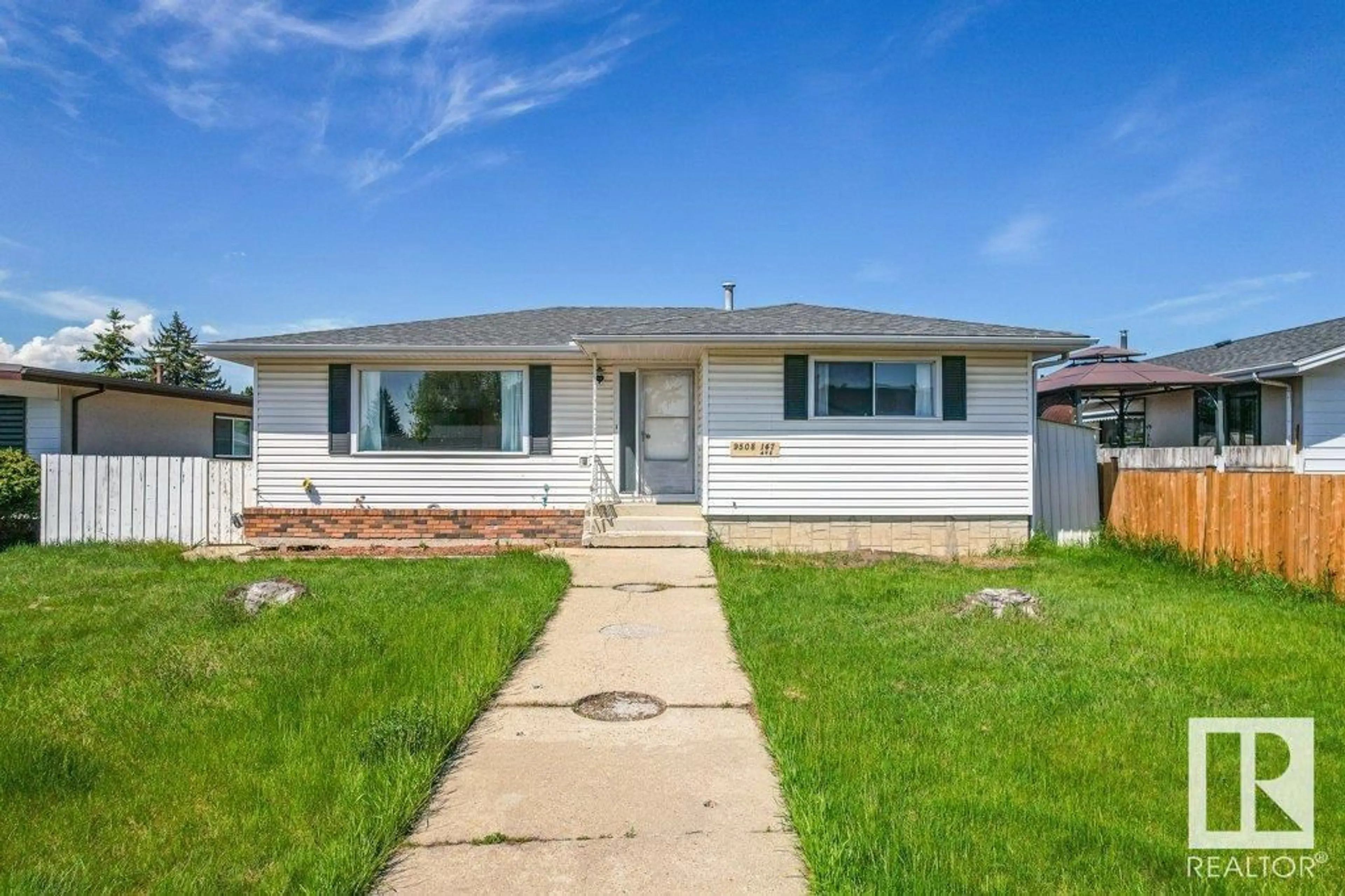 Home with vinyl exterior material, street for 9508 147 AV, Edmonton Alberta T5E2K6