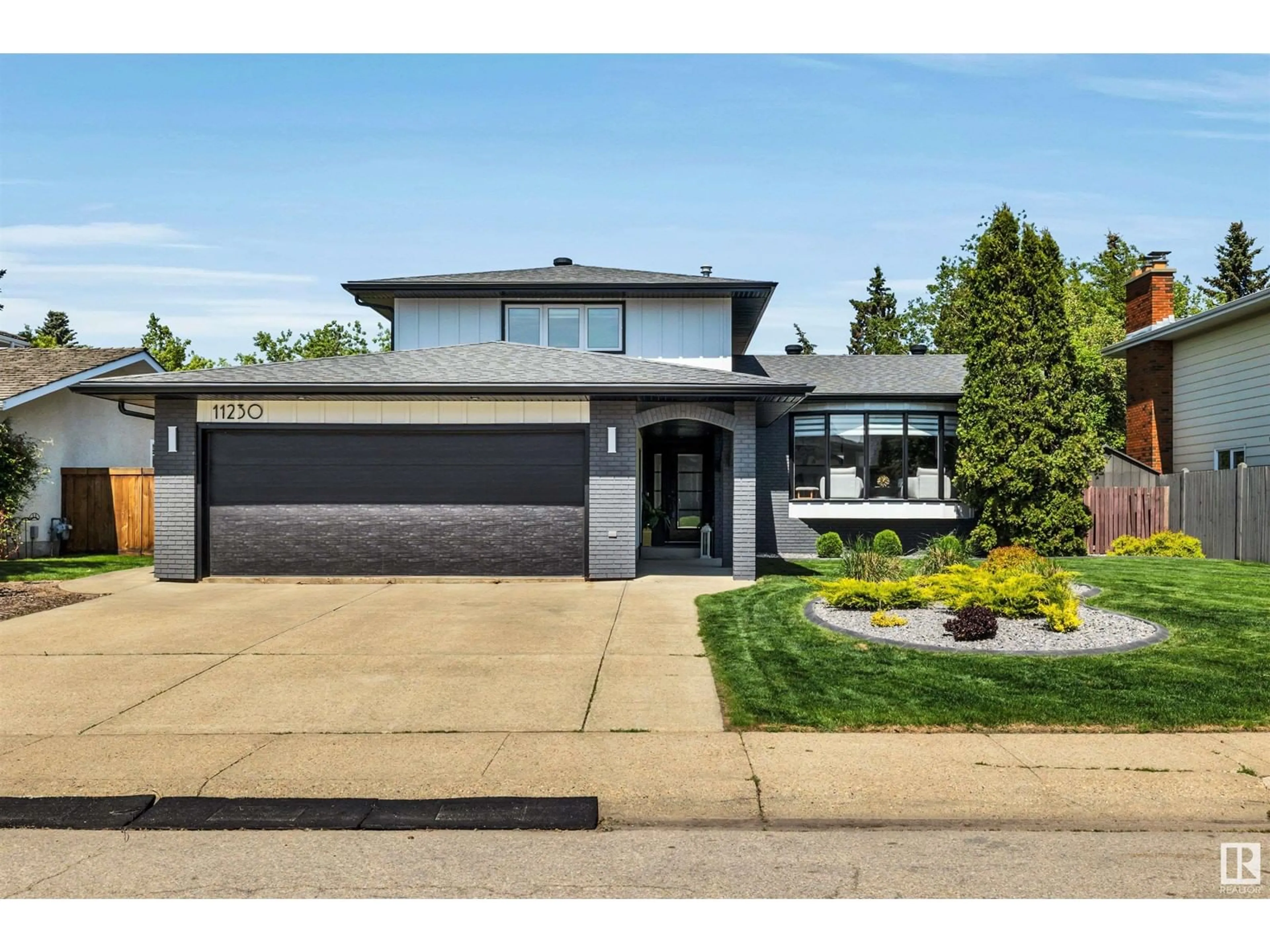 Home with brick exterior material, street for NW - 11230 34A AV, Edmonton Alberta T6J3M5