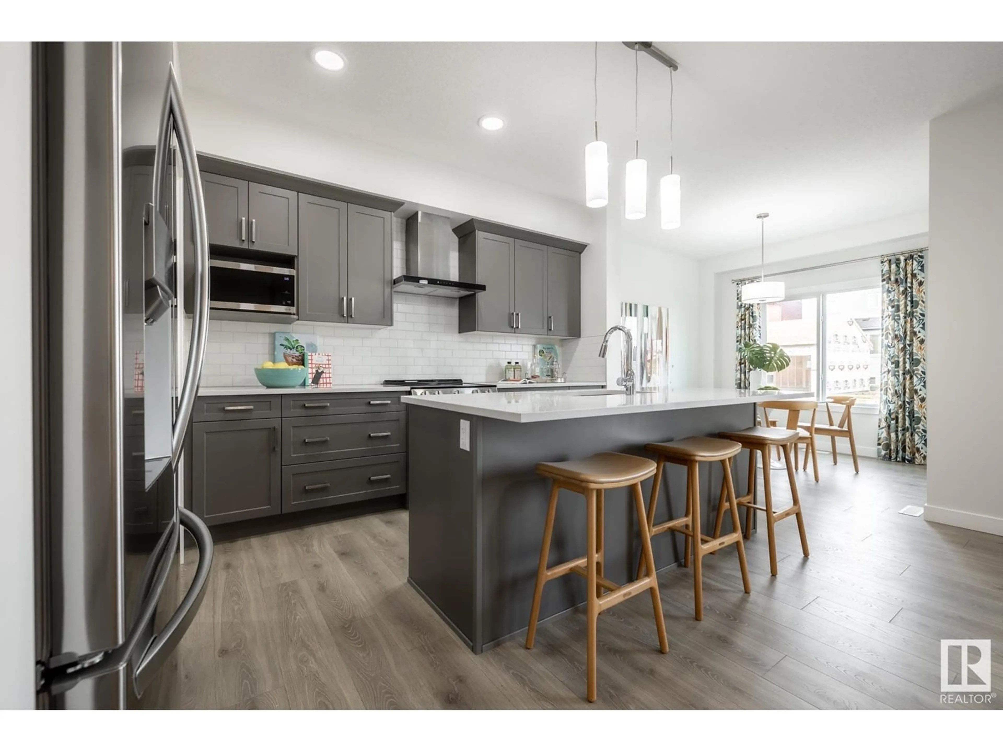 Open concept kitchen, wood/laminate floor for SW - 5264 KINNEY PL, Edmonton Alberta T6M3B5