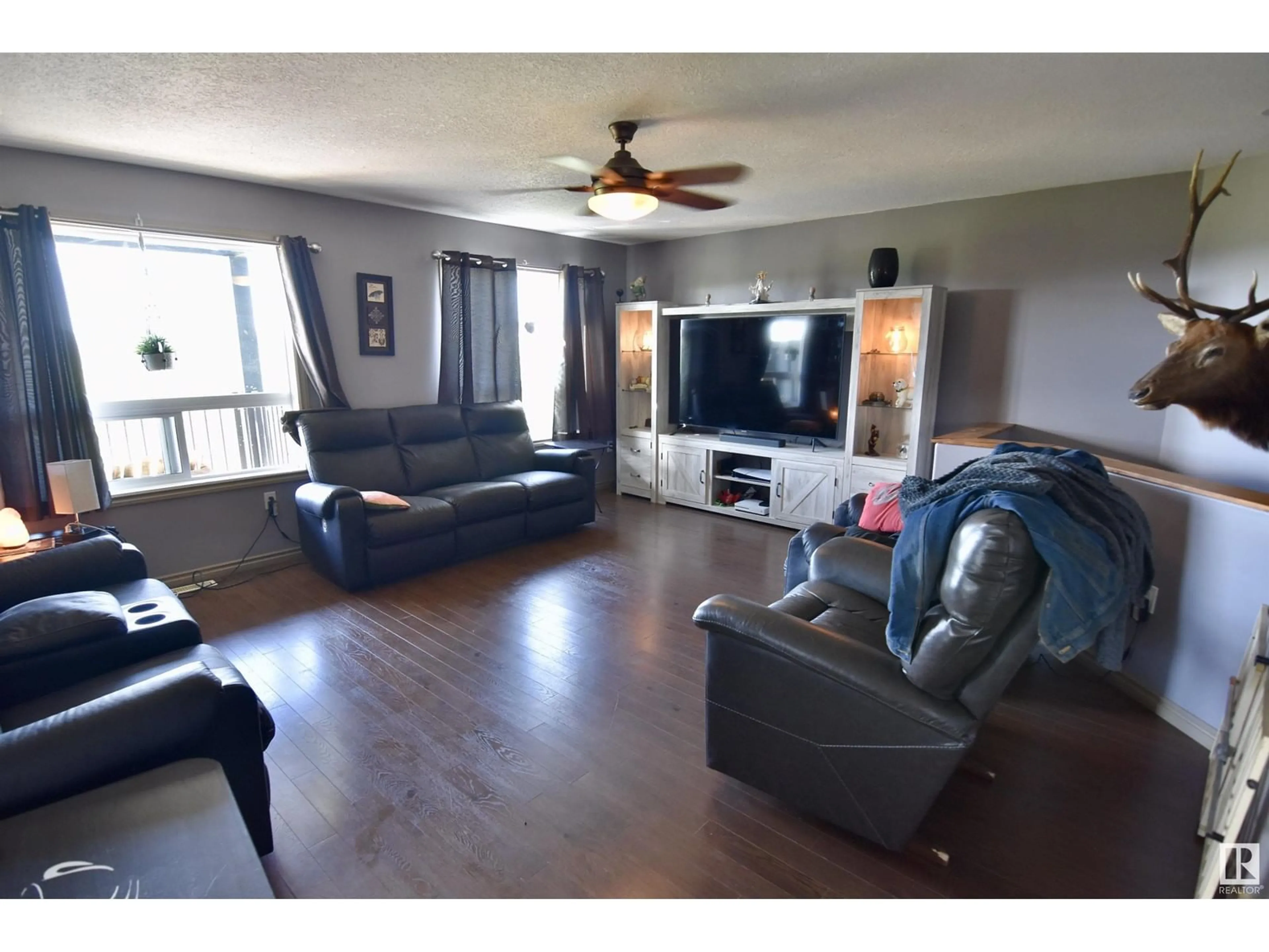 Living room with furniture, wood/laminate floor for 56401 RR 105, Rural St. Paul County Alberta T0A2G0