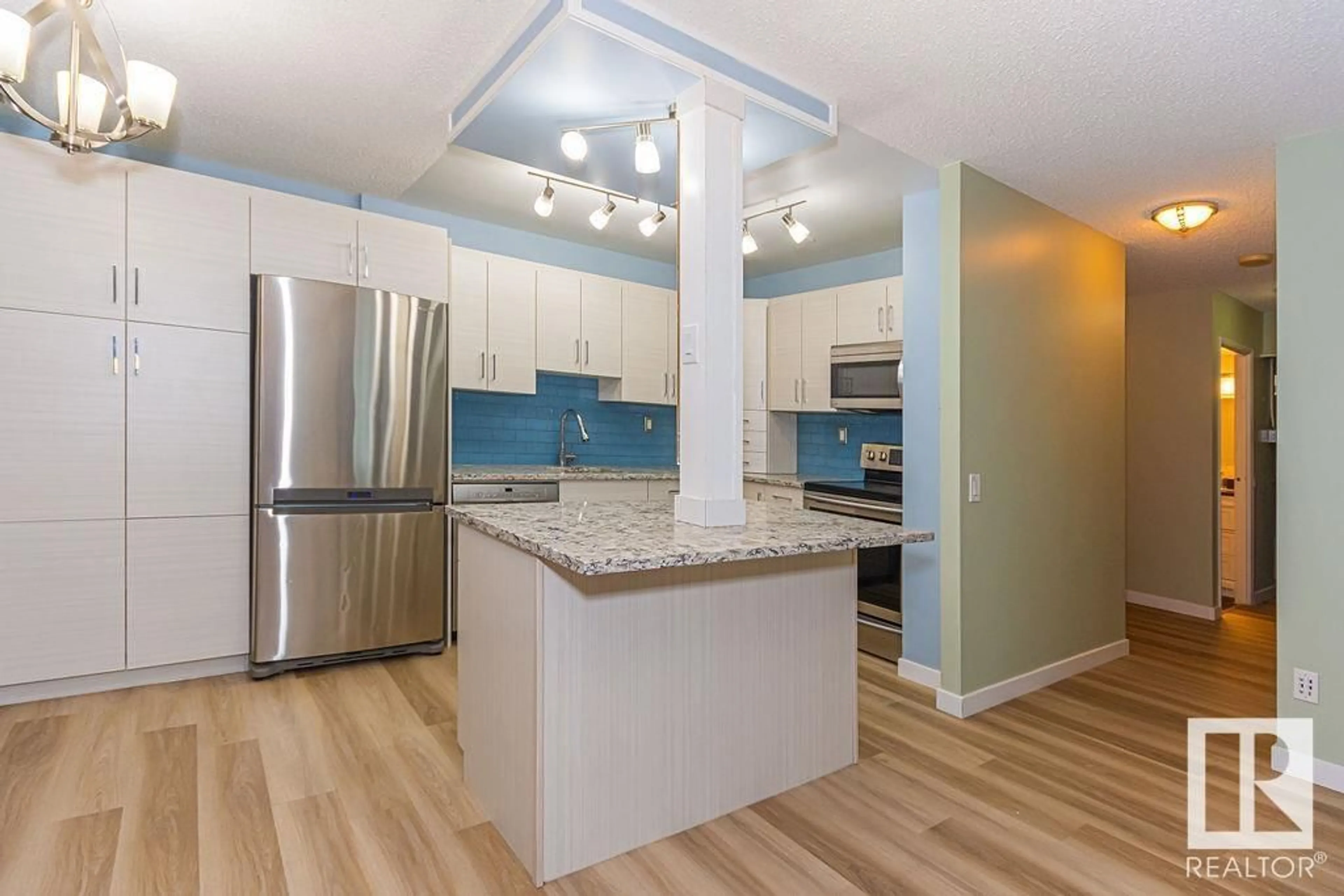 Open concept kitchen, wood/laminate floor for 406 - 10145 109 ST NW, Edmonton Alberta T5J3M5