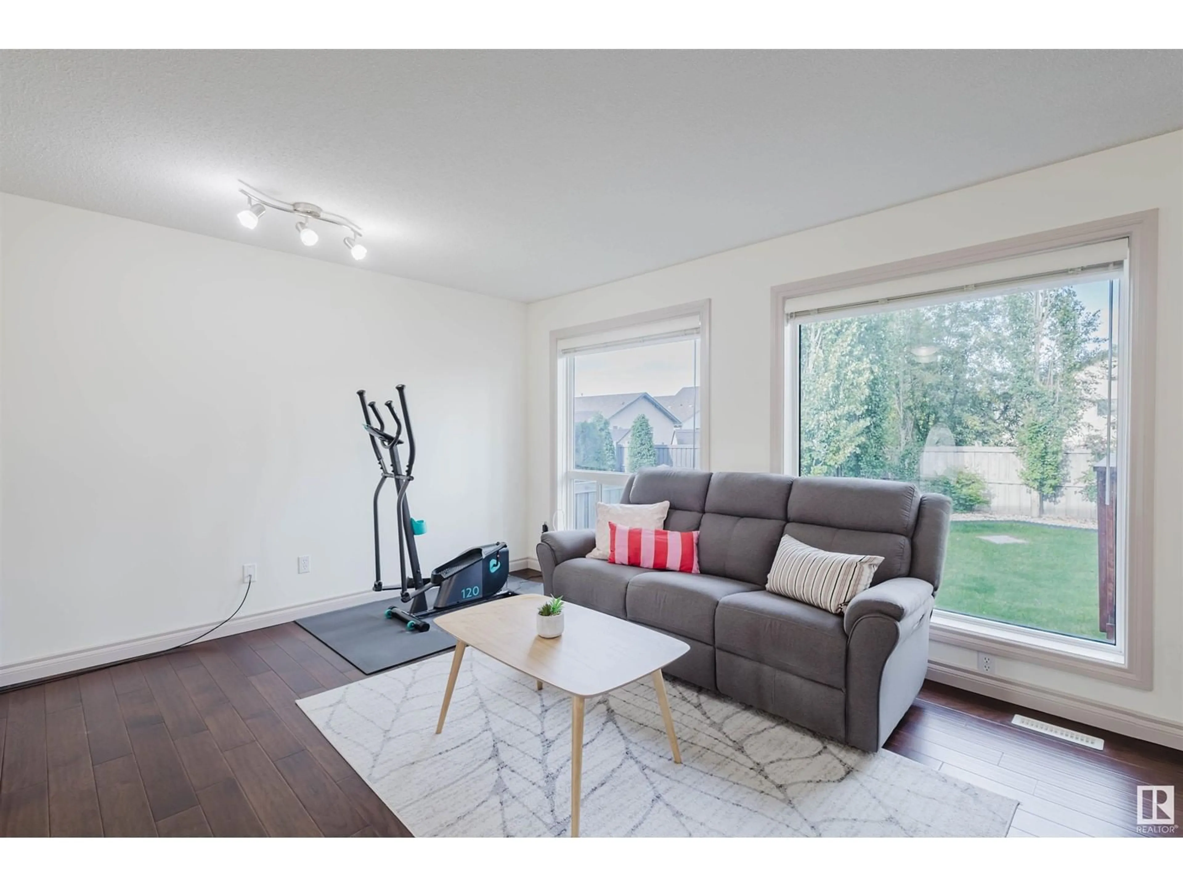 Living room with furniture, wood/laminate floor for NW - 4715 202 ST, Edmonton Alberta T6M2Y1