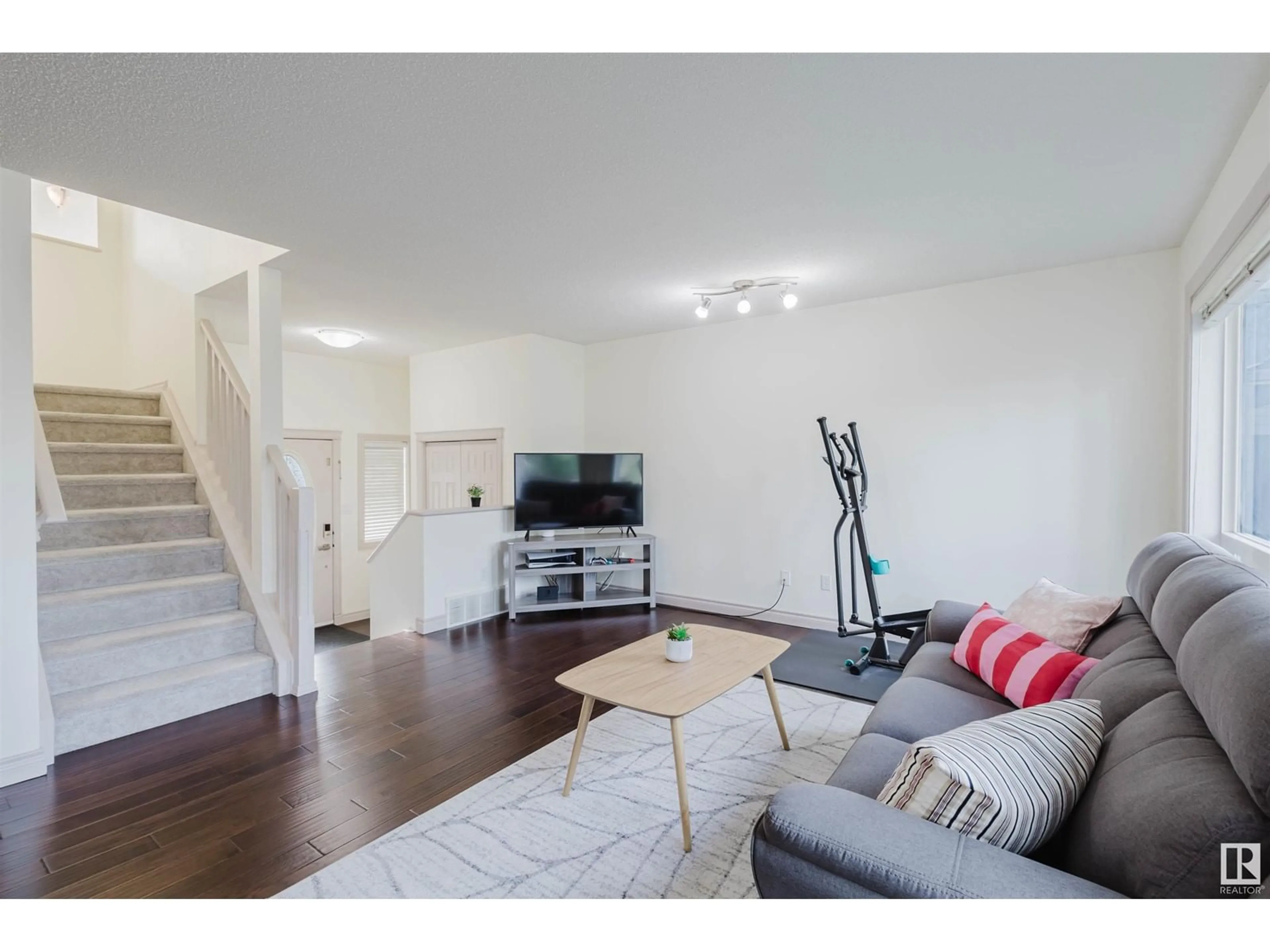 Living room with furniture, wood/laminate floor for NW - 4715 202 ST, Edmonton Alberta T6M2Y1