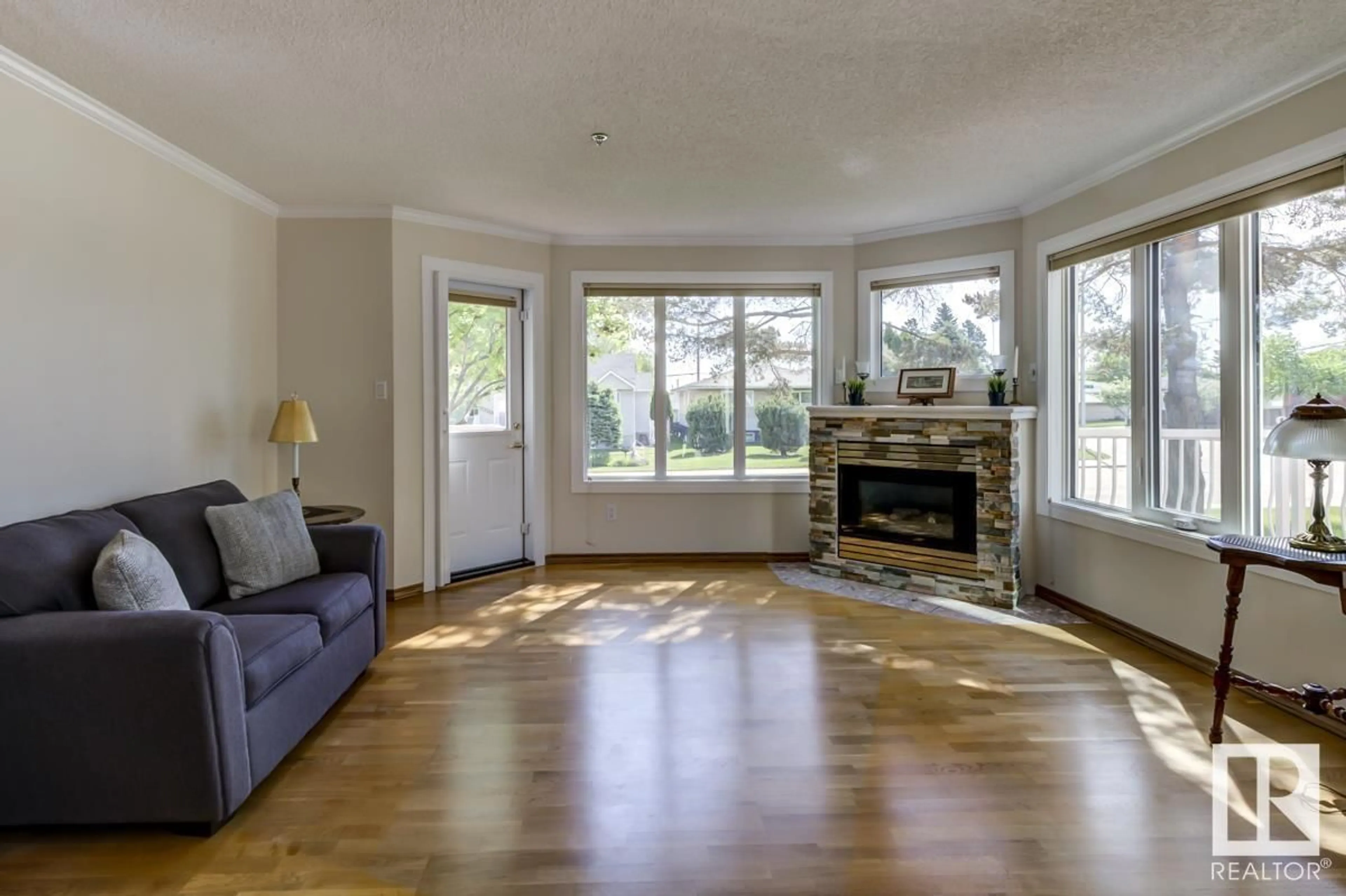 Living room with furniture, wood/laminate floor for 105 - 10610 76 ST, Edmonton Alberta T6A3Y9