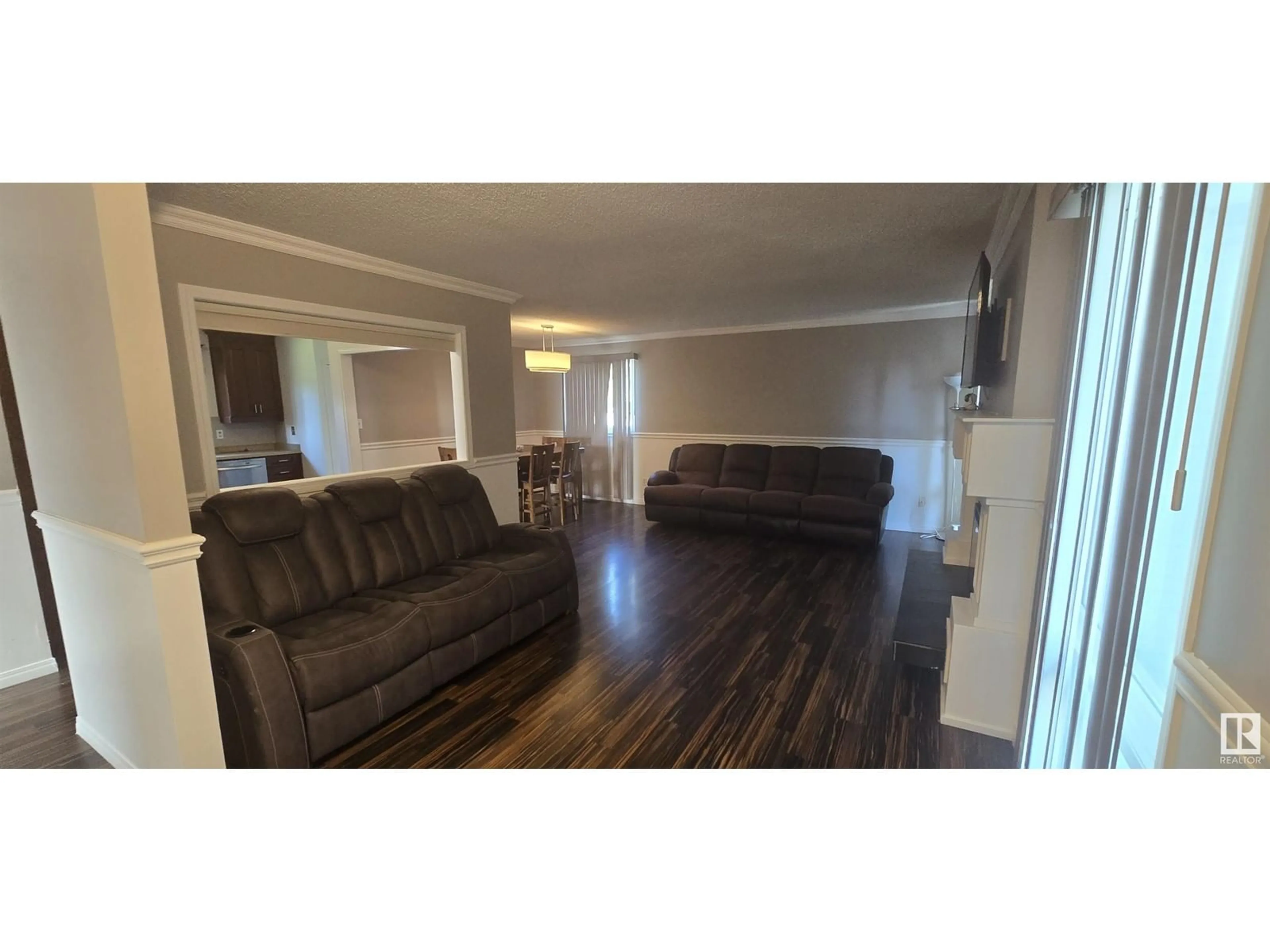 Living room with furniture, wood/laminate floor for 2727 83 STREET, Edmonton Alberta T6K3G7