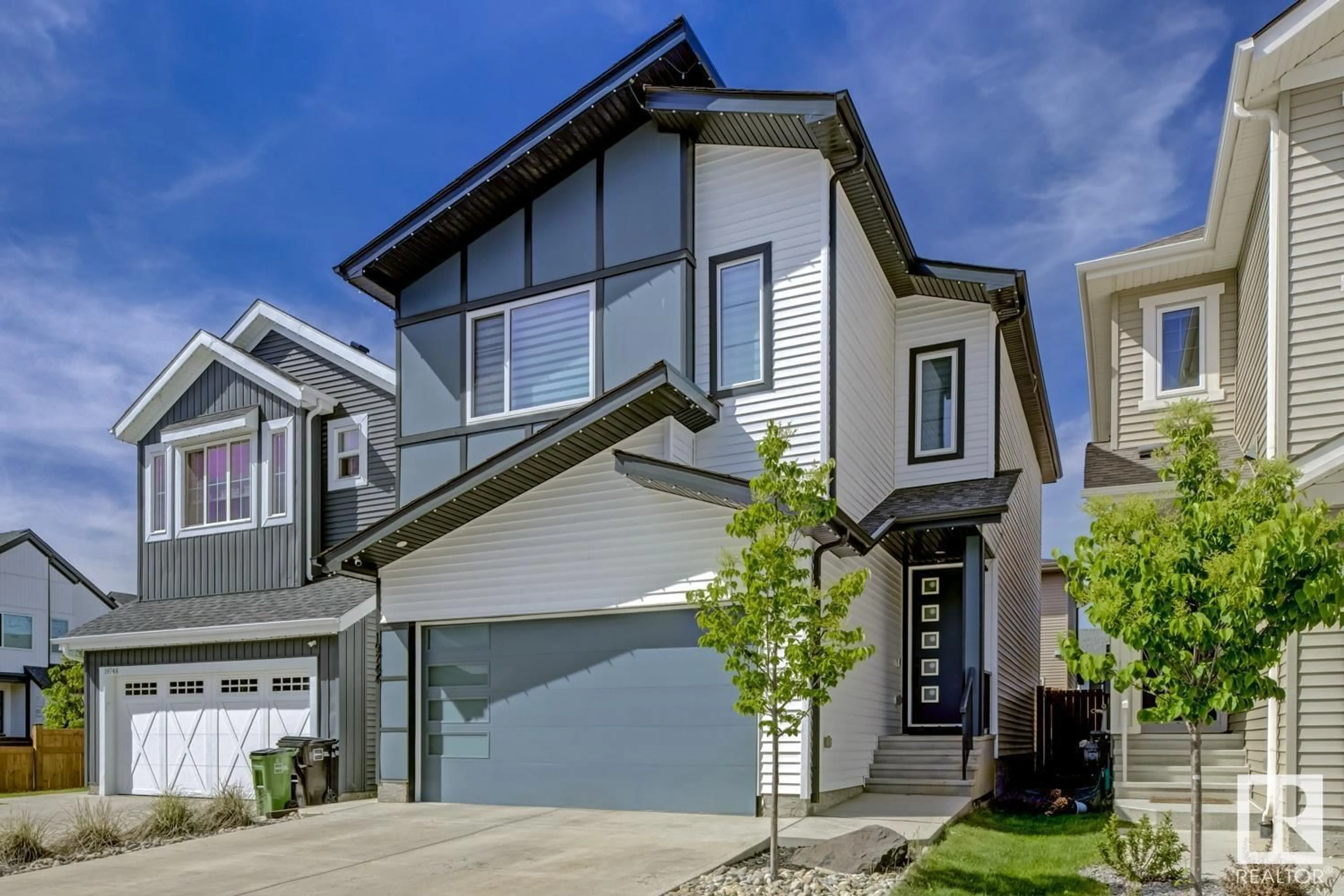 Home with vinyl exterior material, street for 19744 28 AV, Edmonton Alberta T6M1M1