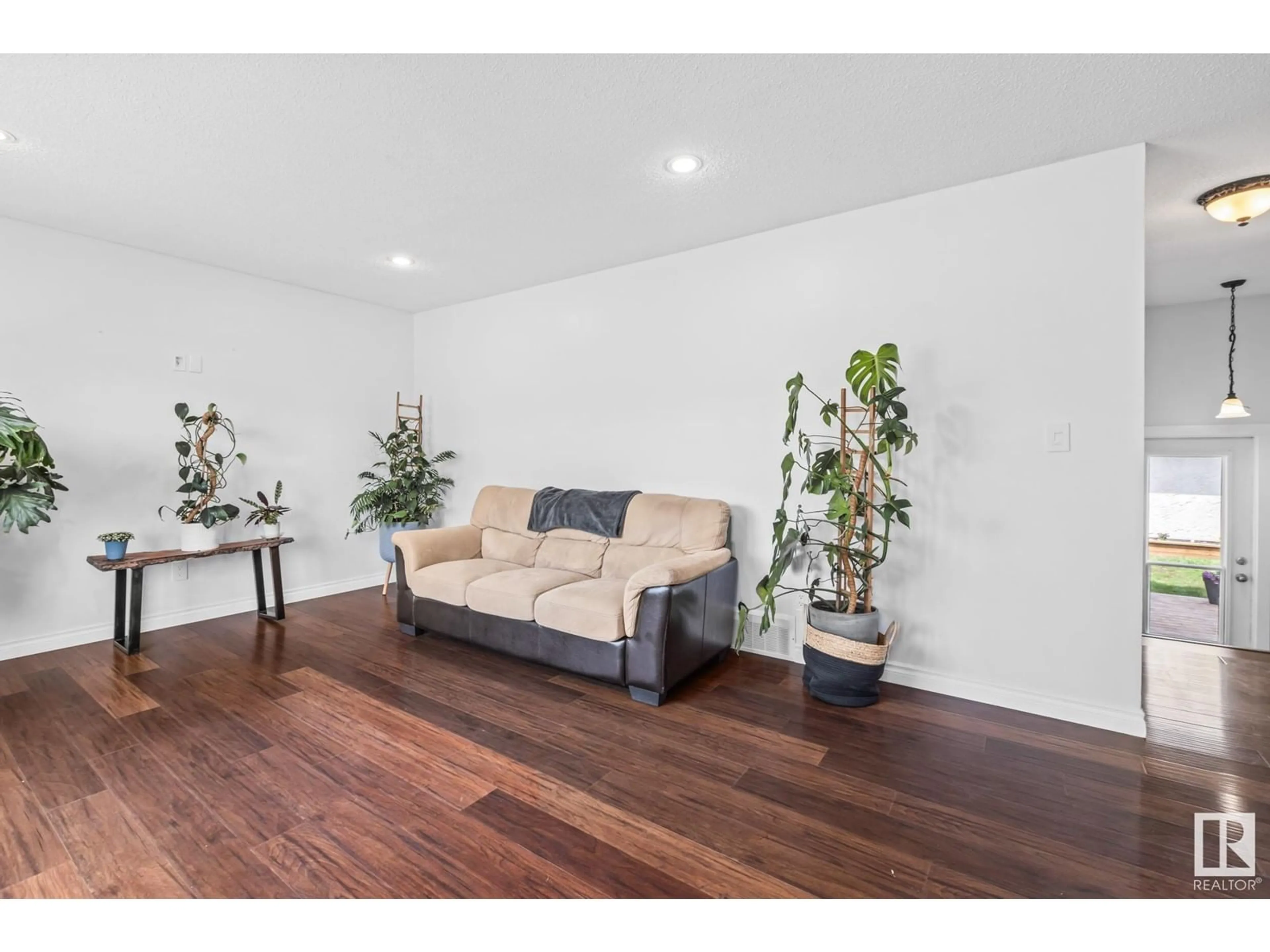 Living room with furniture, wood/laminate floor for 9208 MORINVILLE DR, Morinville Alberta T8R1J7
