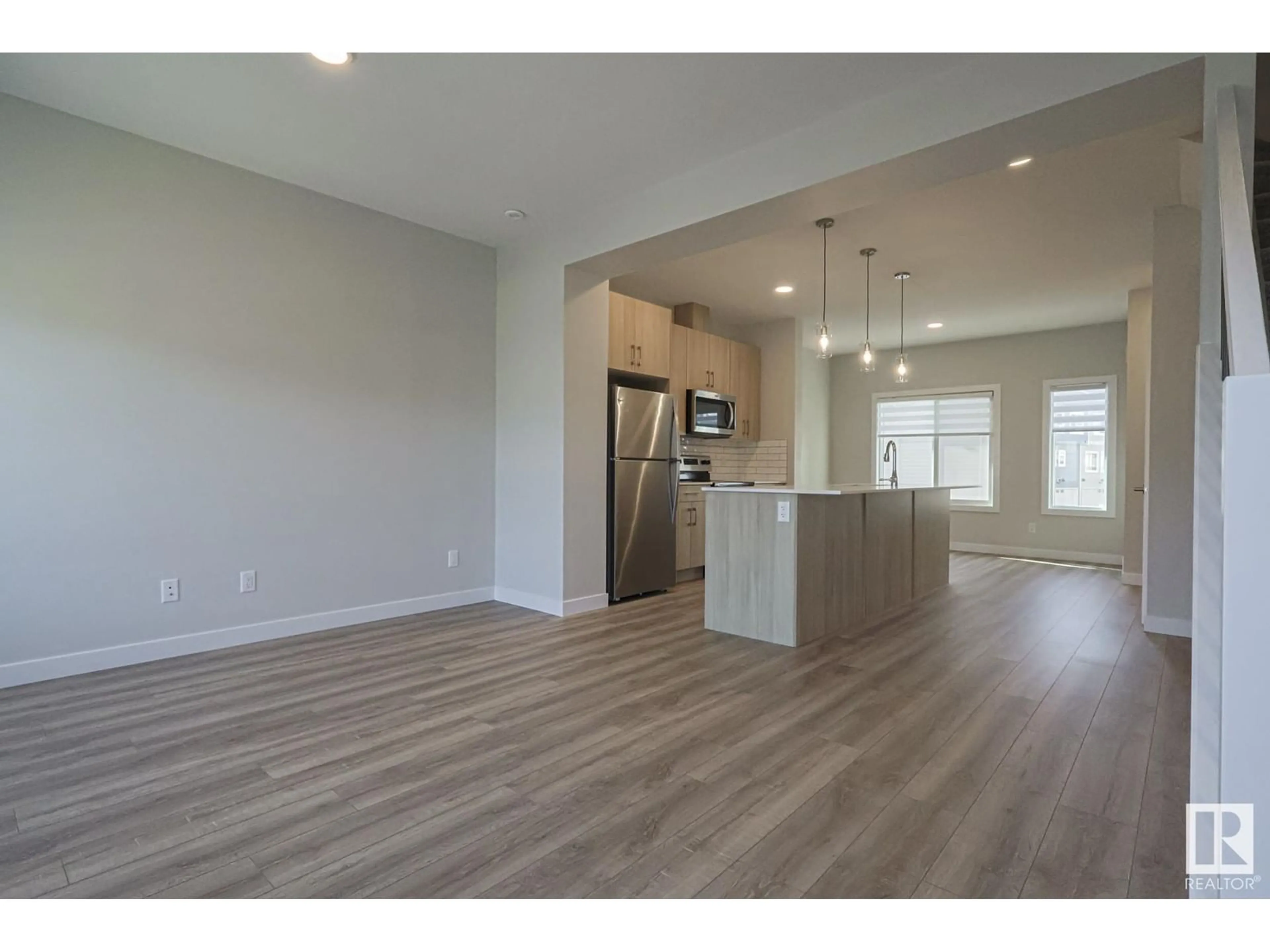 Open concept kitchen, wood/laminate floor for 5087 CHAPPELLE RD, Edmonton Alberta T6W5A7