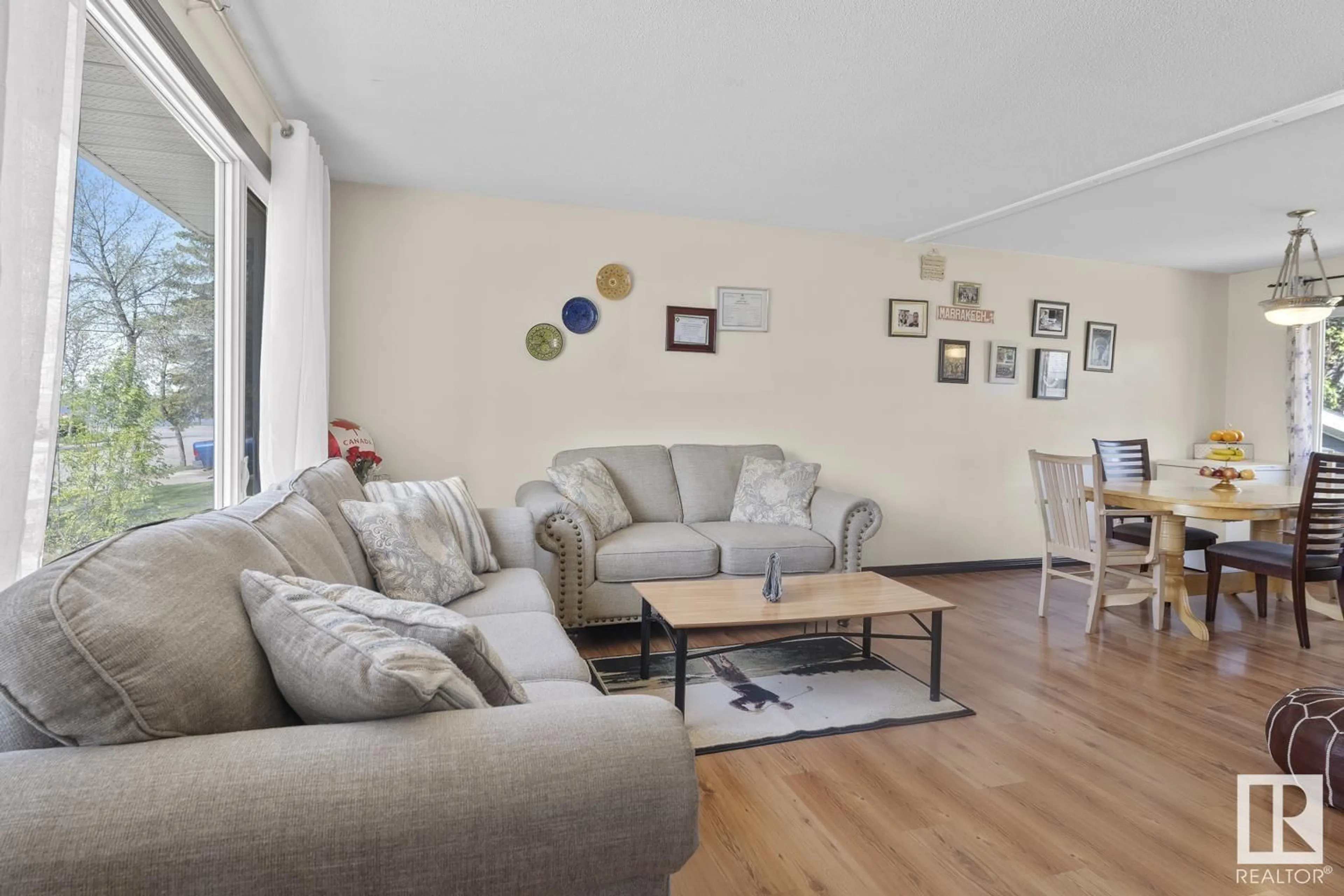 Living room with furniture, wood/laminate floor for 4729 44 AV, Bonnyville Town Alberta T9N1N6