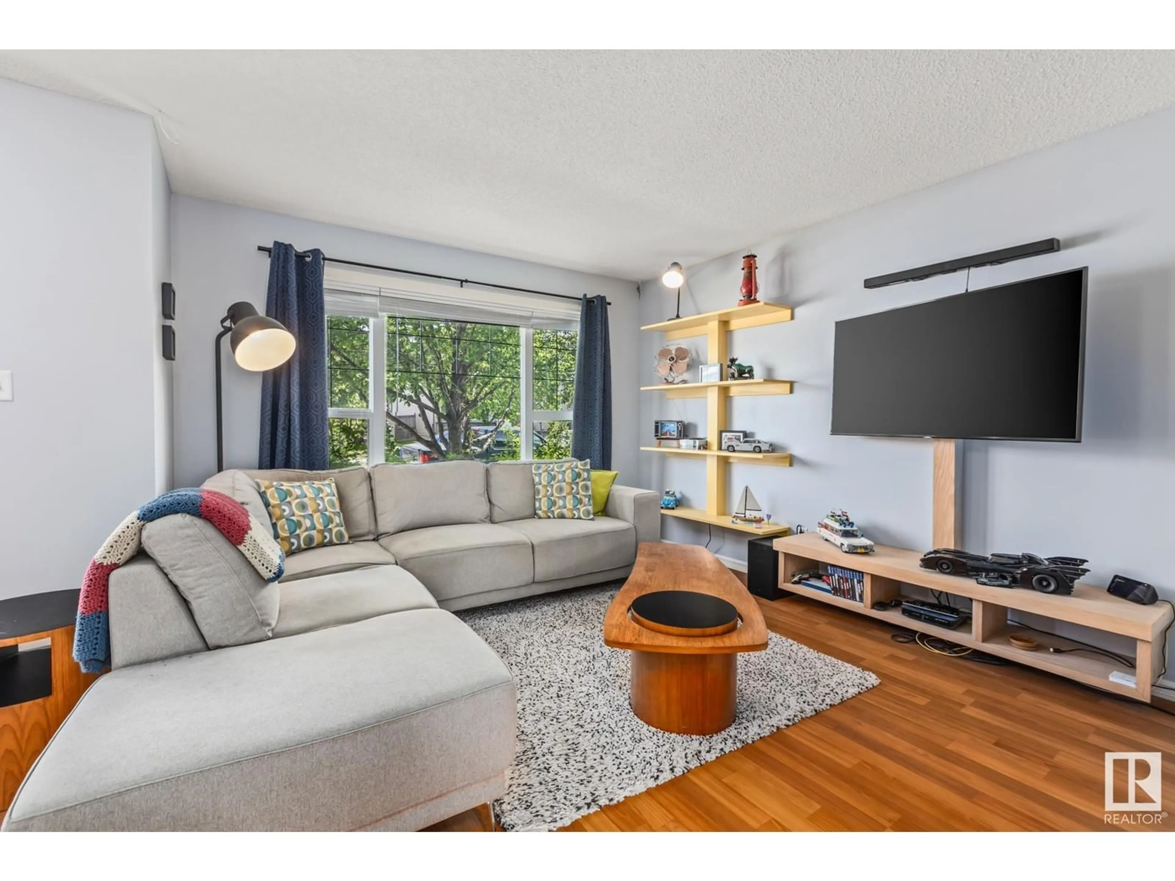 Living room with furniture, wood/laminate floor for SW - 118 63 ST, Edmonton Alberta T6X0C1