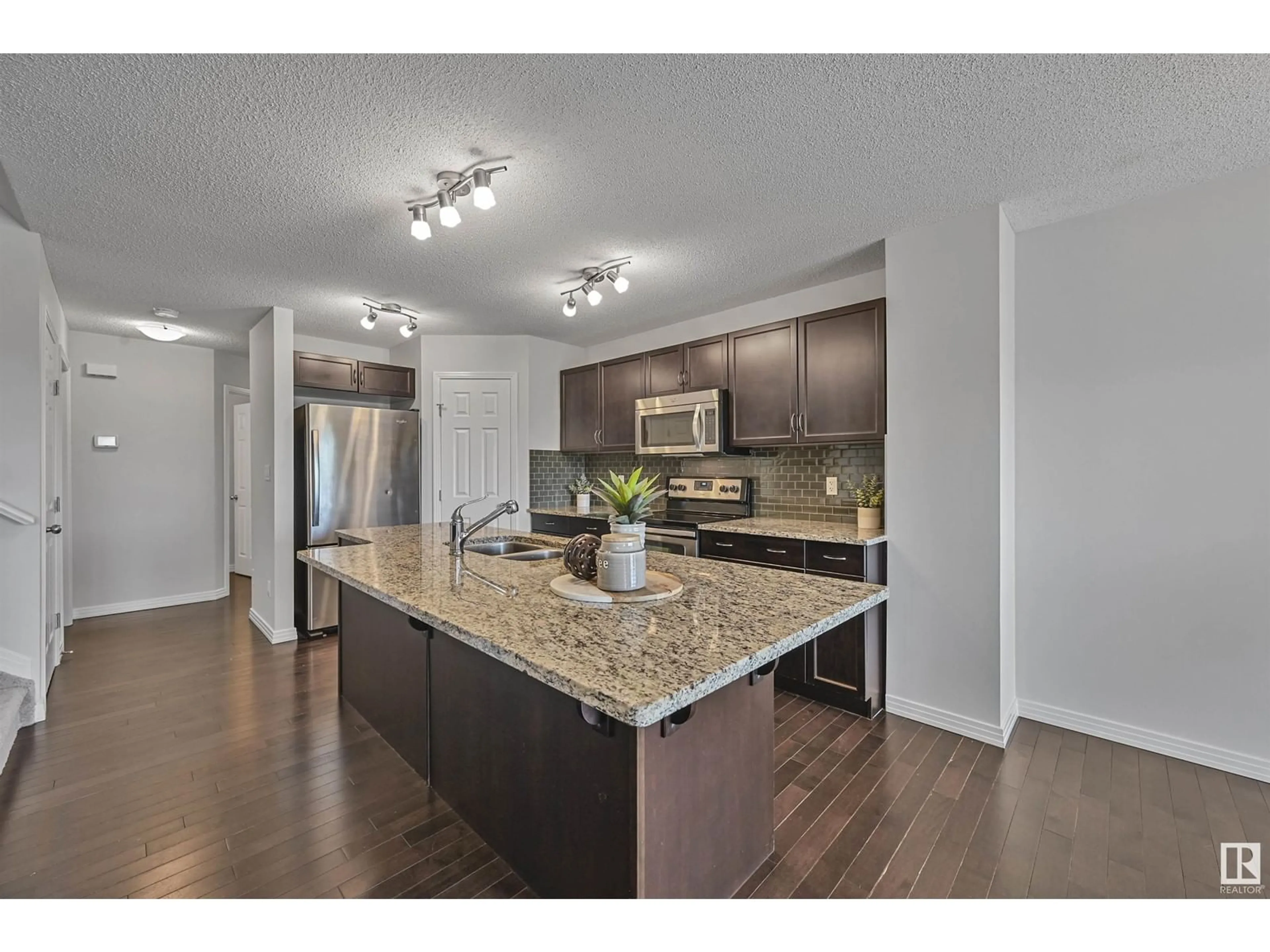 Open concept kitchen, wood/laminate floor for 16329 134 ST, Edmonton Alberta T6V0G4