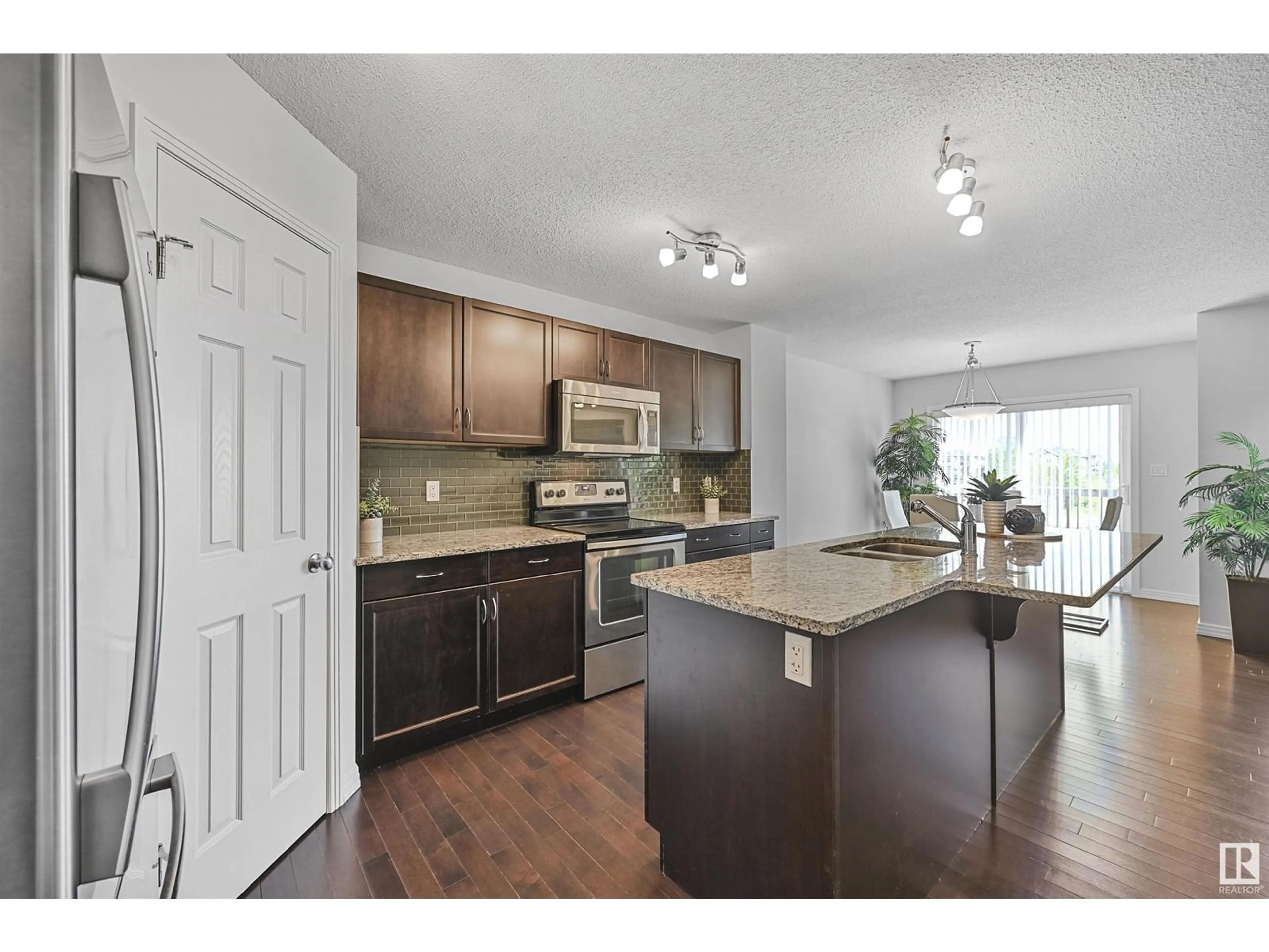 Open concept kitchen, wood/laminate floor for 16329 134 ST, Edmonton Alberta T6V0G4