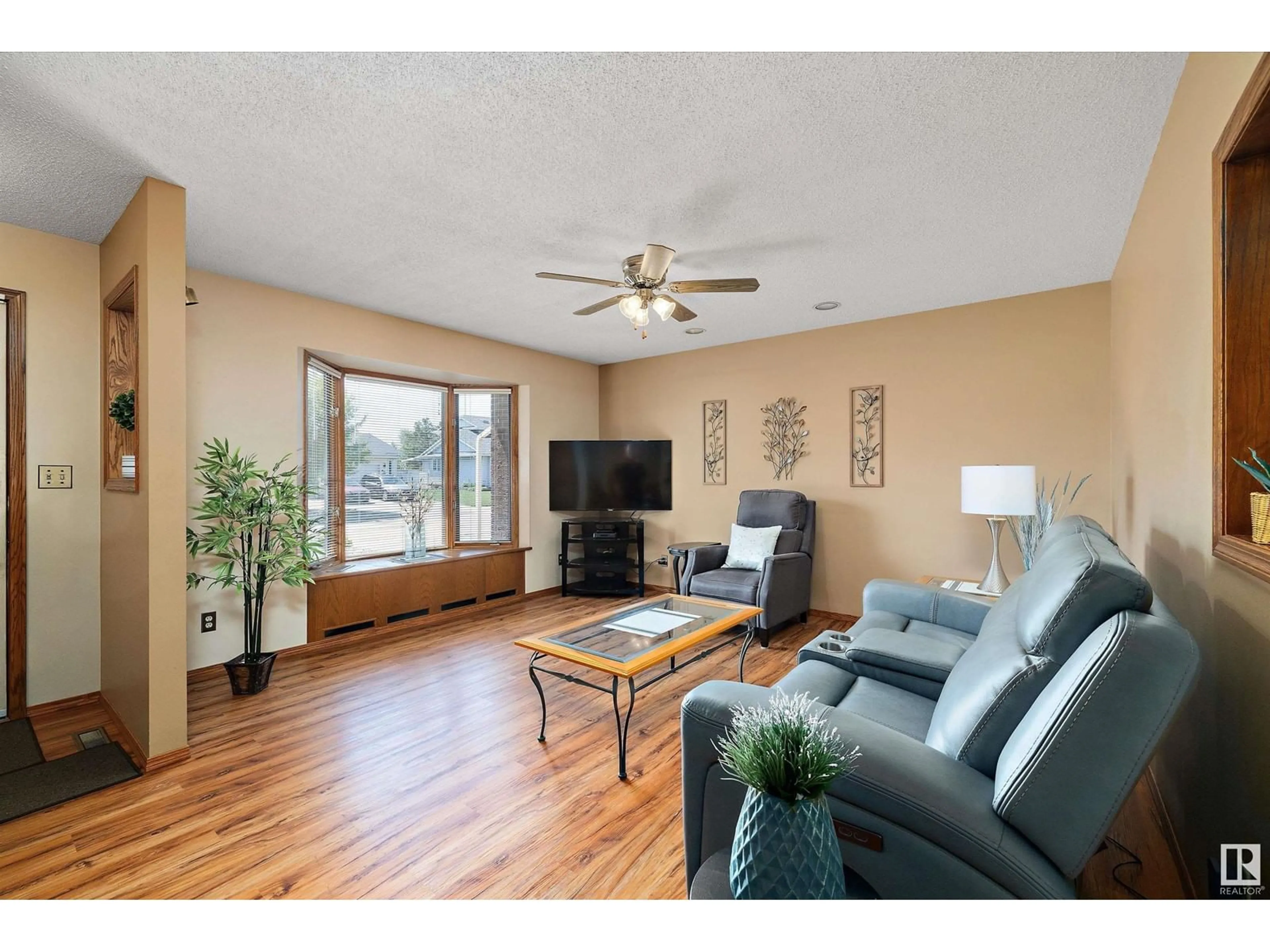 Living room with furniture, wood/laminate floor for 4312 124 AV, Edmonton Alberta T5W5B9