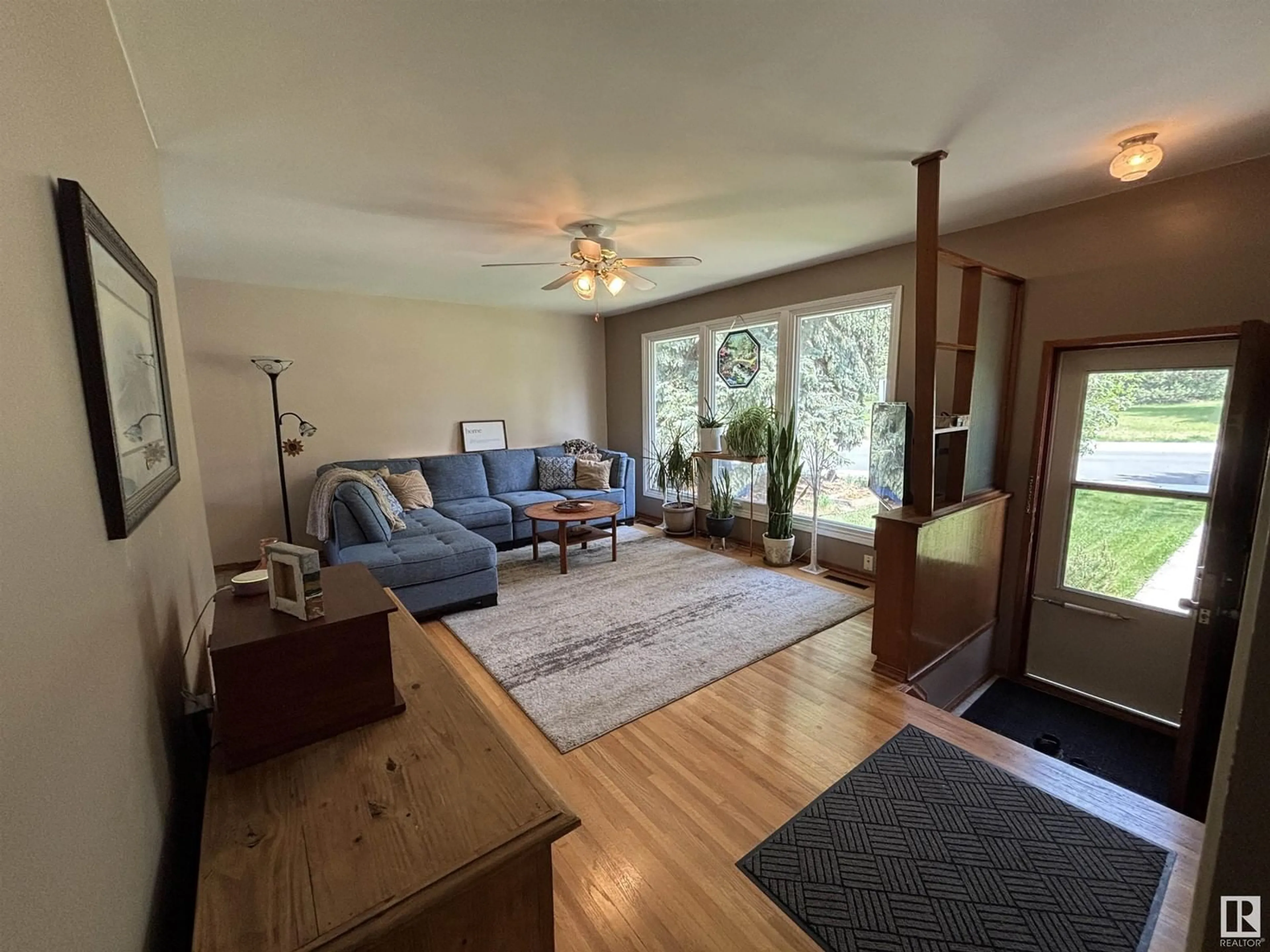 Living room with furniture, wood/laminate floor for NW - 5208 107 ST, Edmonton Alberta T6H2X2