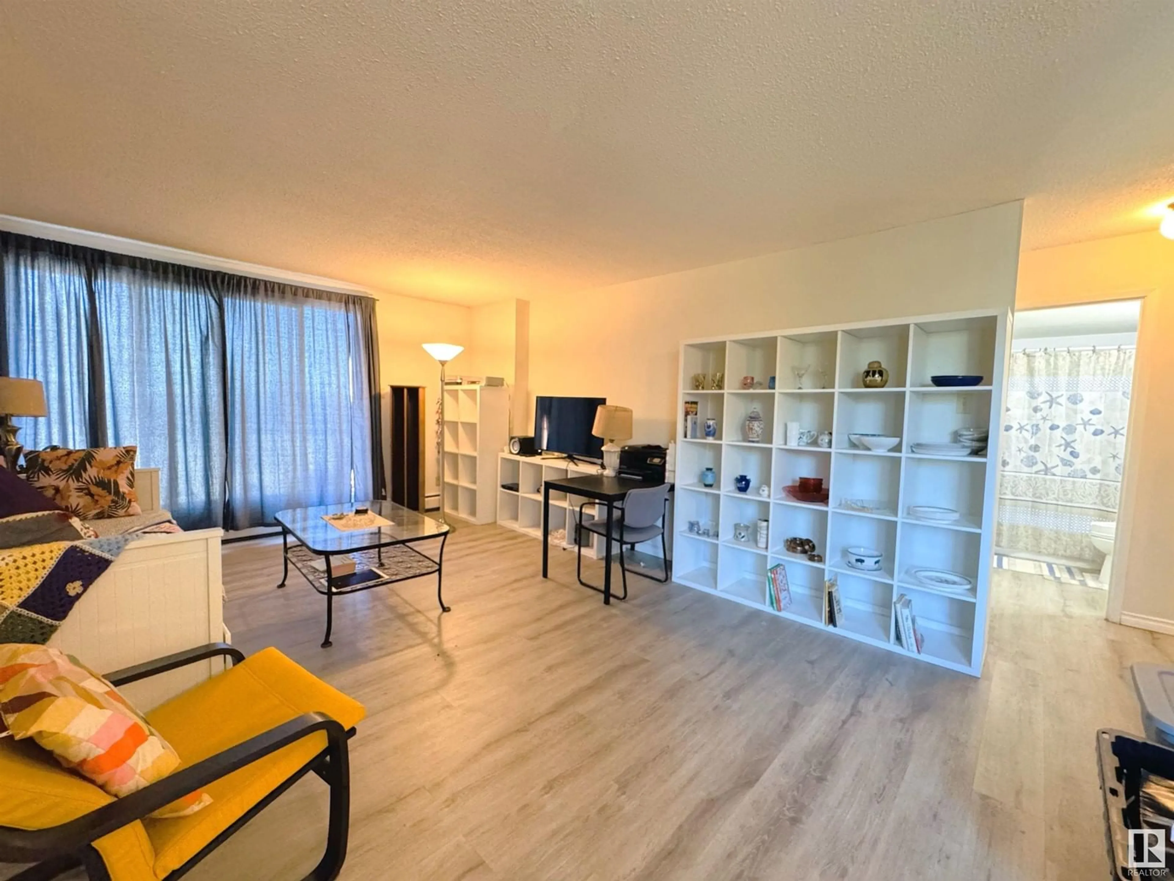 Living room with furniture, wood/laminate floor for 207 - 9028 JASPER AV, Edmonton Alberta T5H3Y6