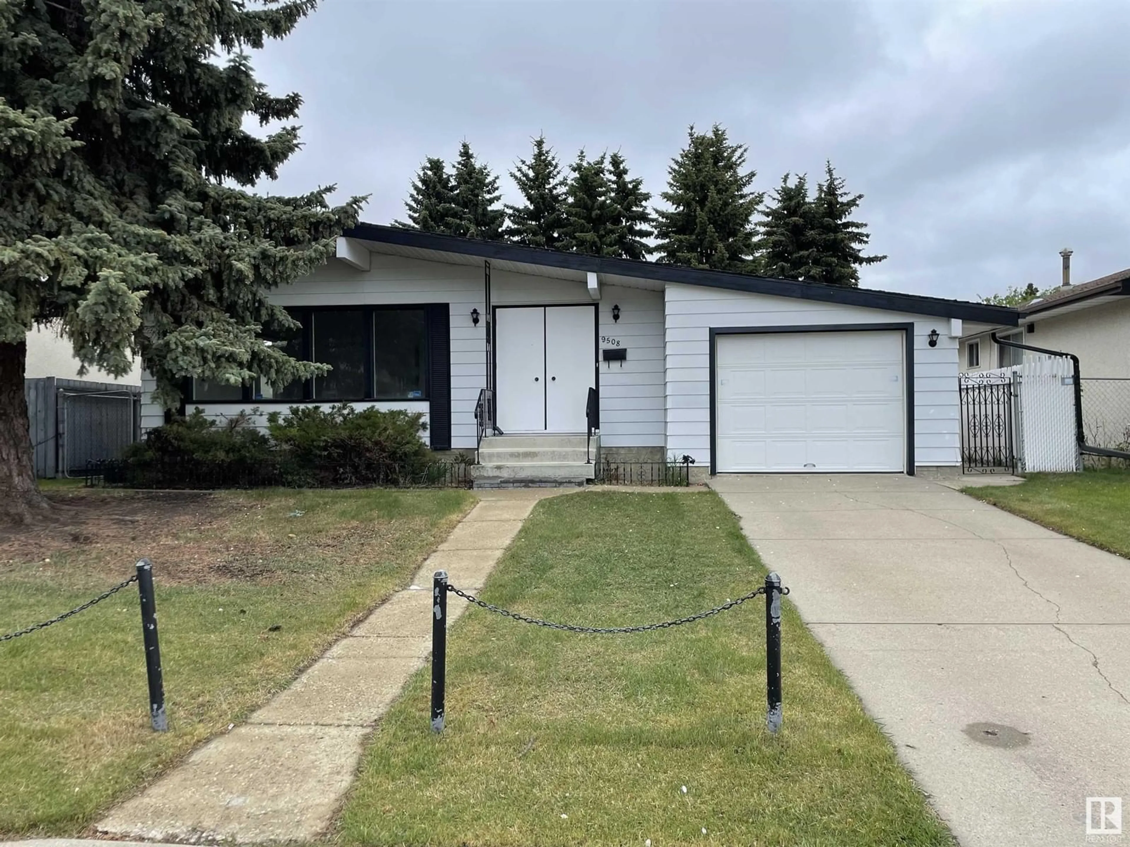 Home with vinyl exterior material, street for 9508 145 AV, Edmonton Alberta T5E2J7