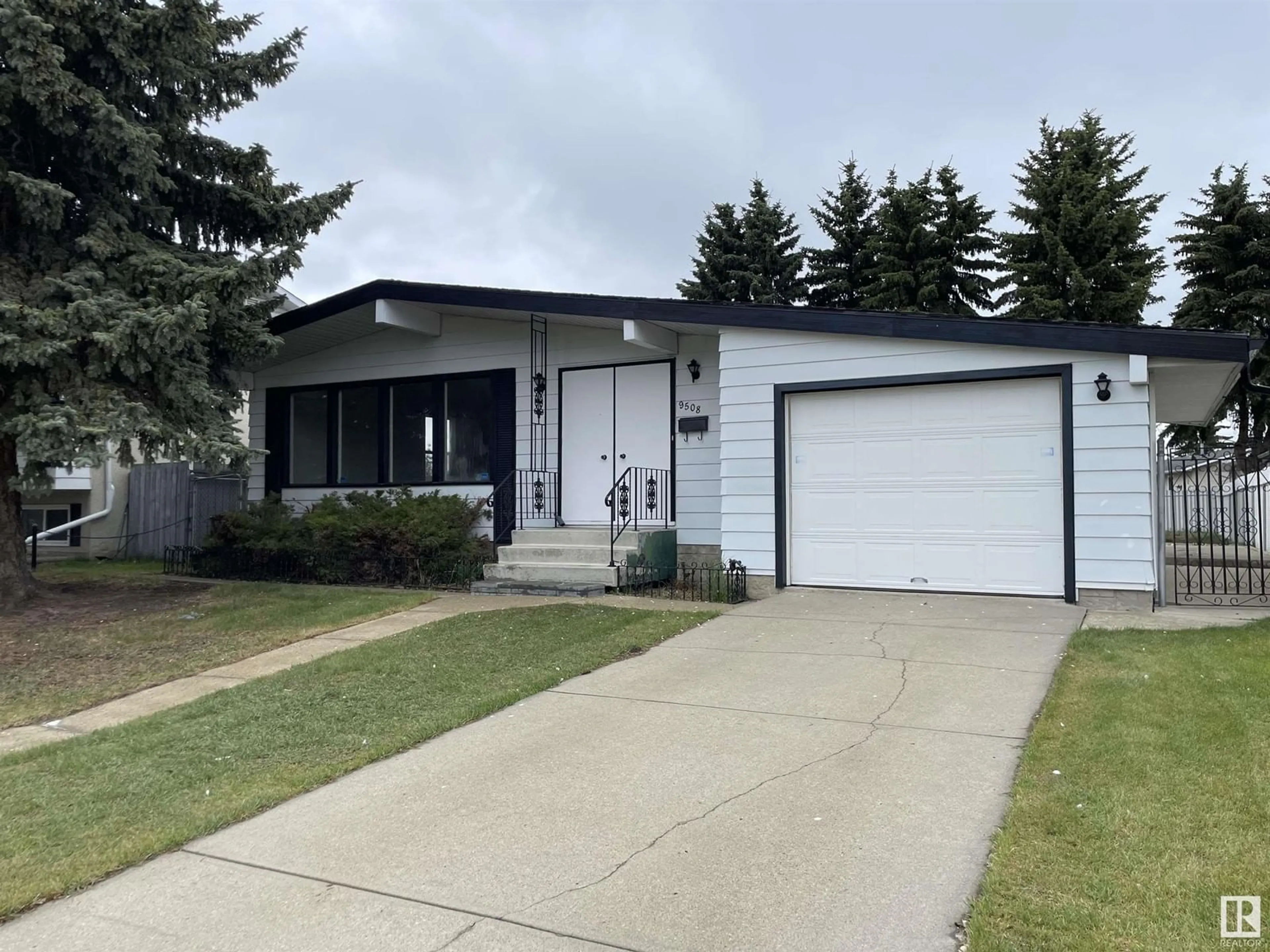 Home with vinyl exterior material, street for 9508 145 AV, Edmonton Alberta T5E2J7