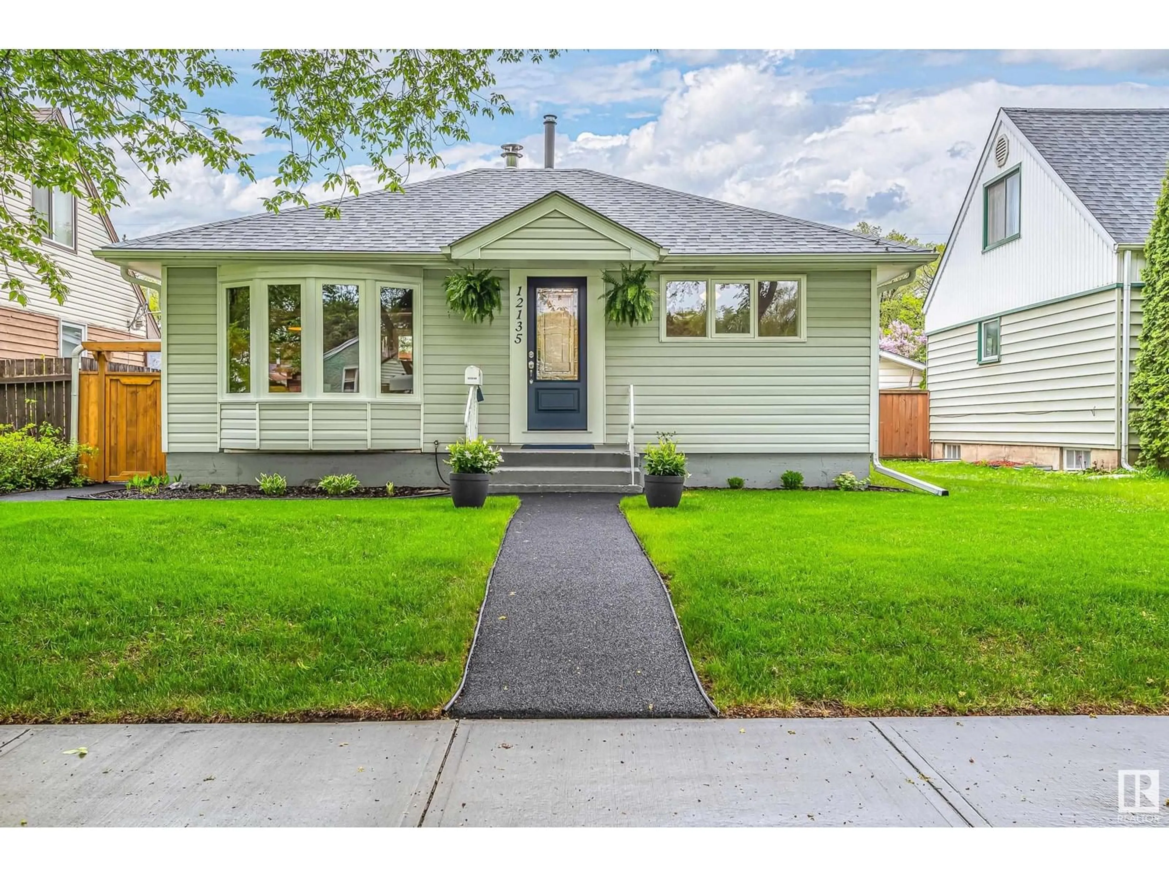 Home with vinyl exterior material, street for 12135 60 ST, Edmonton Alberta T5W3Z7