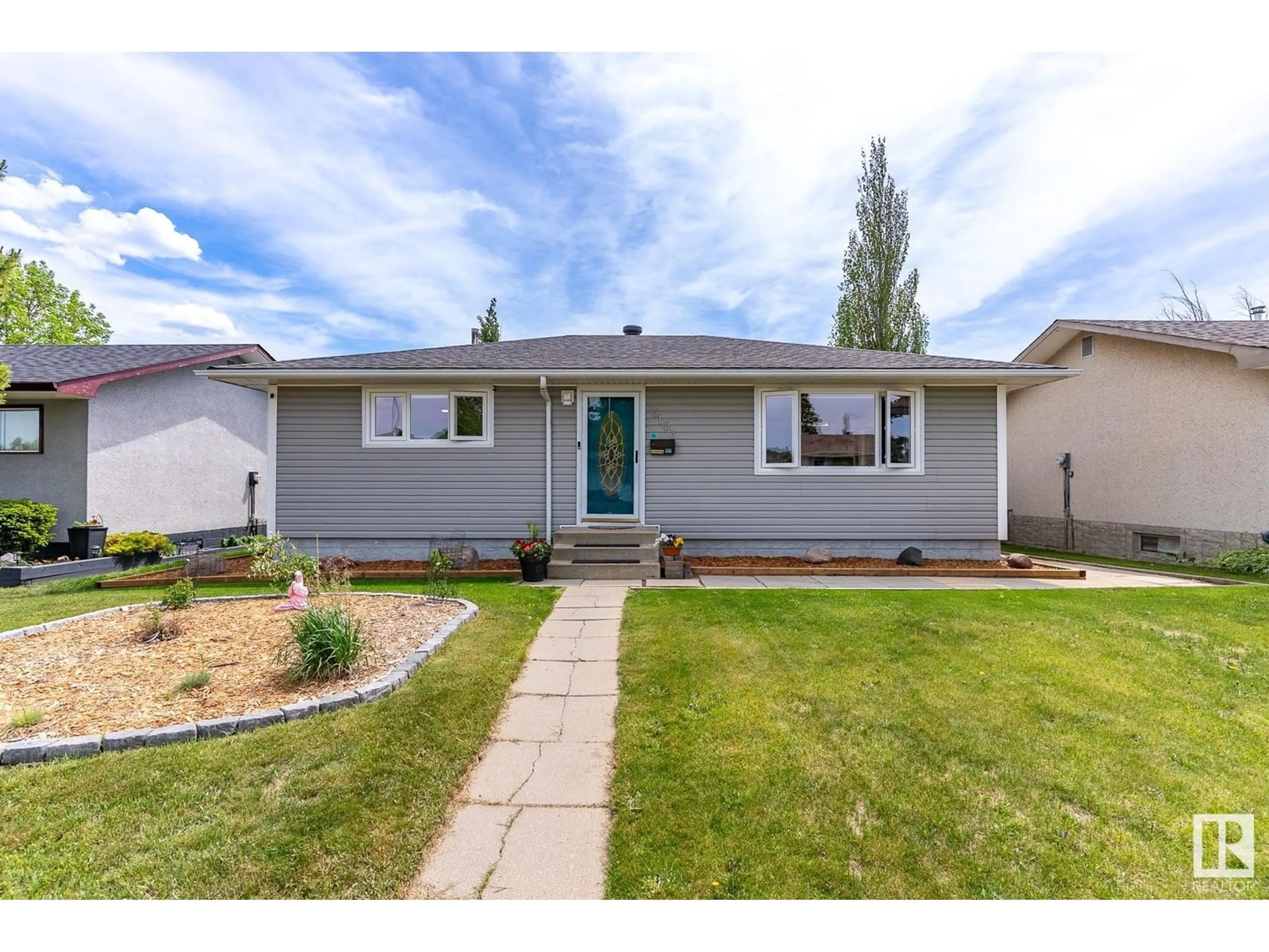 Home with vinyl exterior material, street for 3103 111 AV, Edmonton Alberta T5W0J2