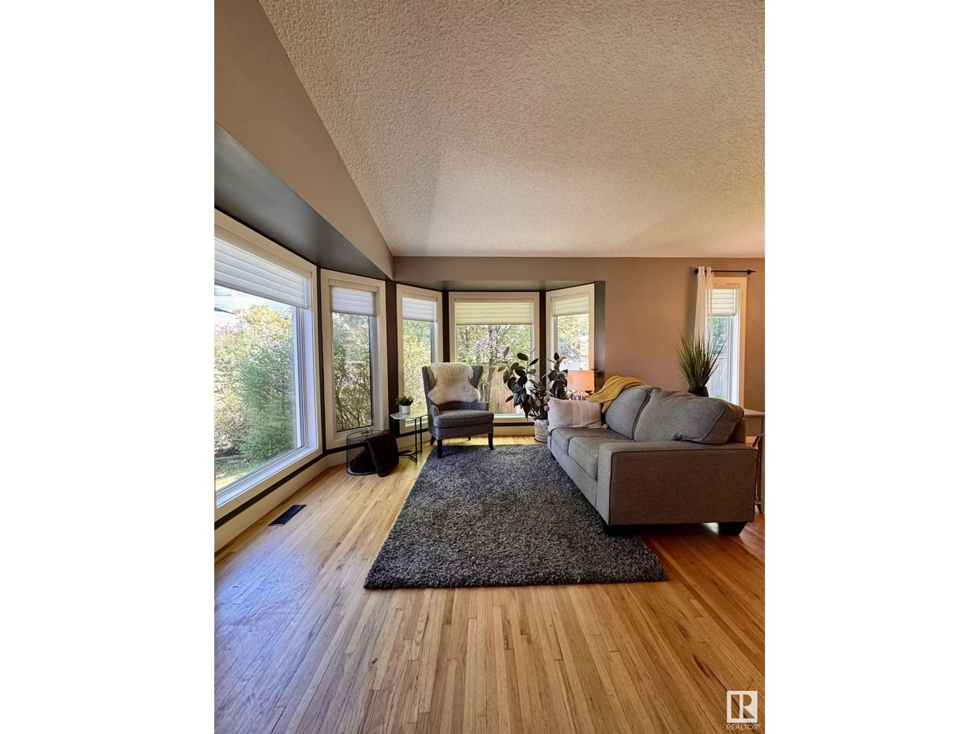 Living room with furniture, wood/laminate floor for 5601 54 ST, Beaumont Alberta T4X1L7