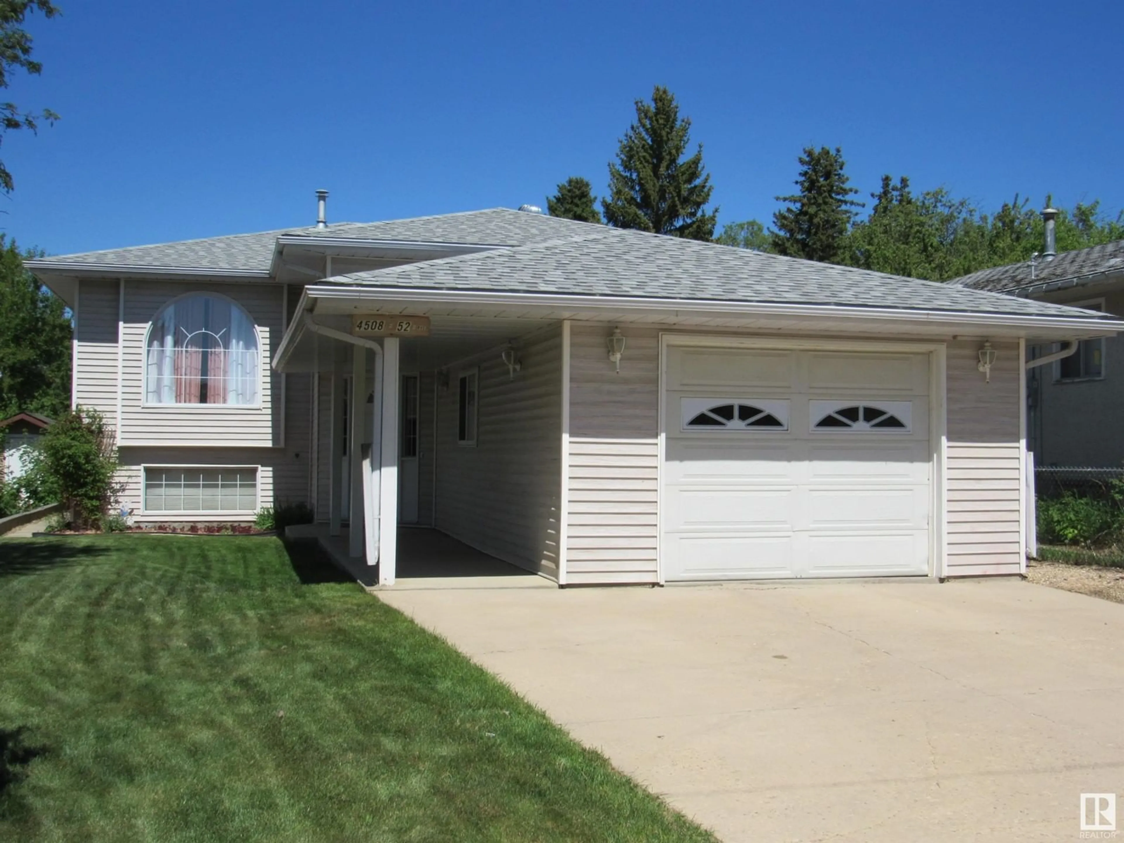 Home with vinyl exterior material, street for 4508 52 AV, Barrhead Alberta T7N1J1