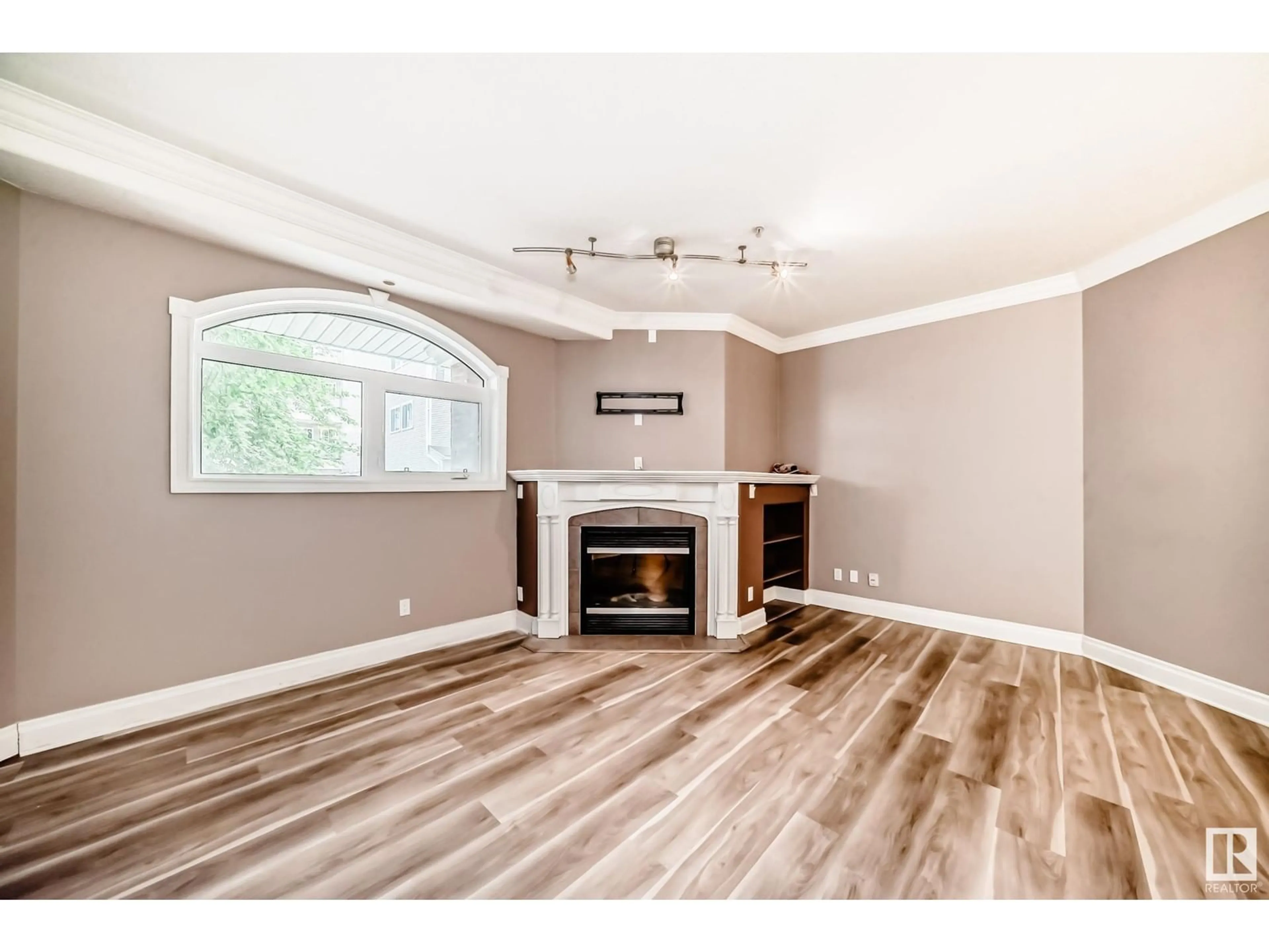 Living room with furniture, wood/laminate floor for 105 - 10178 117 ST, Edmonton Alberta T5K2X9