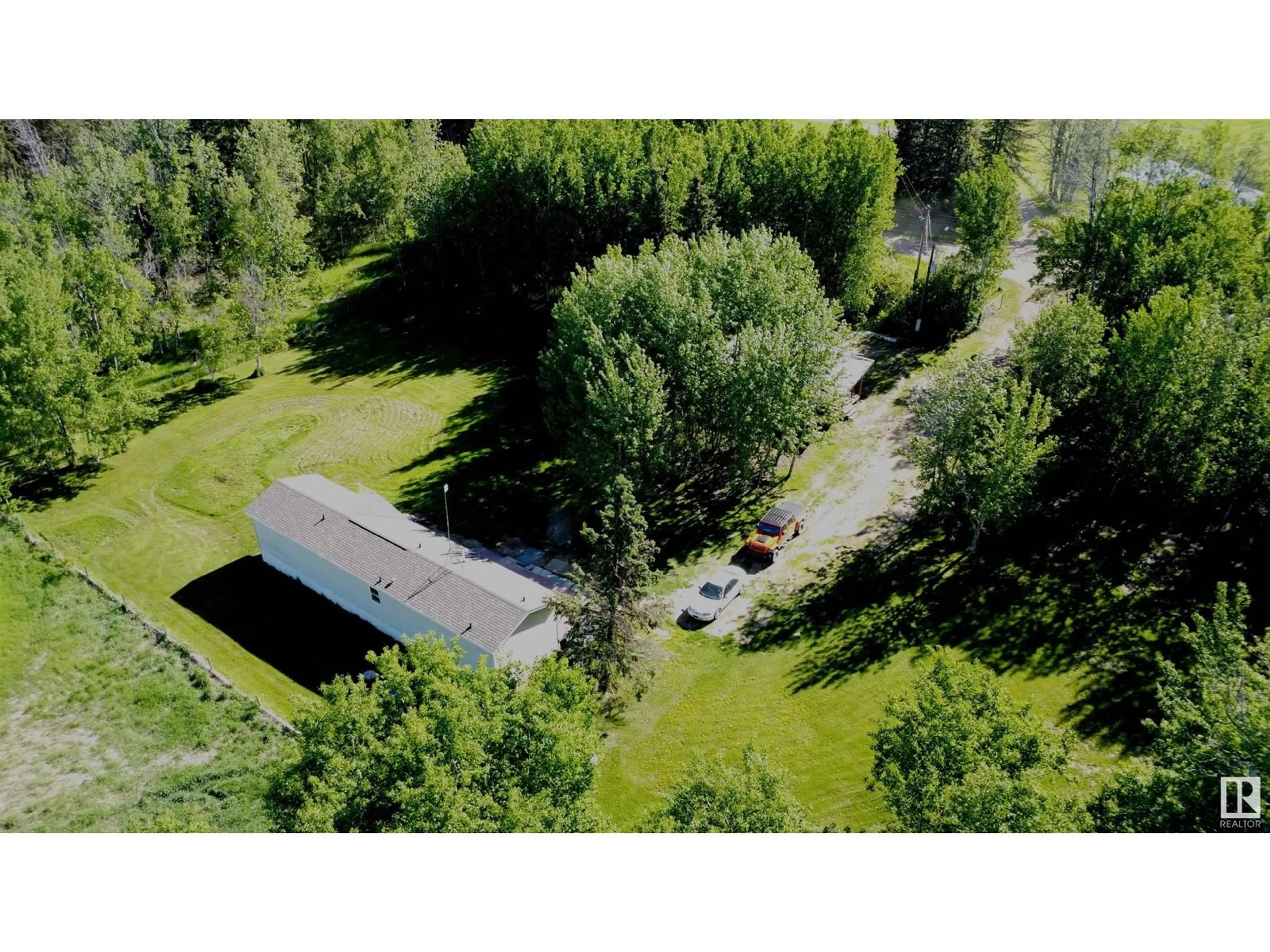 A pic from outside/outdoor area/front of a property/back of a property/a pic from drone, forest/trees view for 58518 RGE RD 60, Rural Barrhead County Alberta T7N1N3