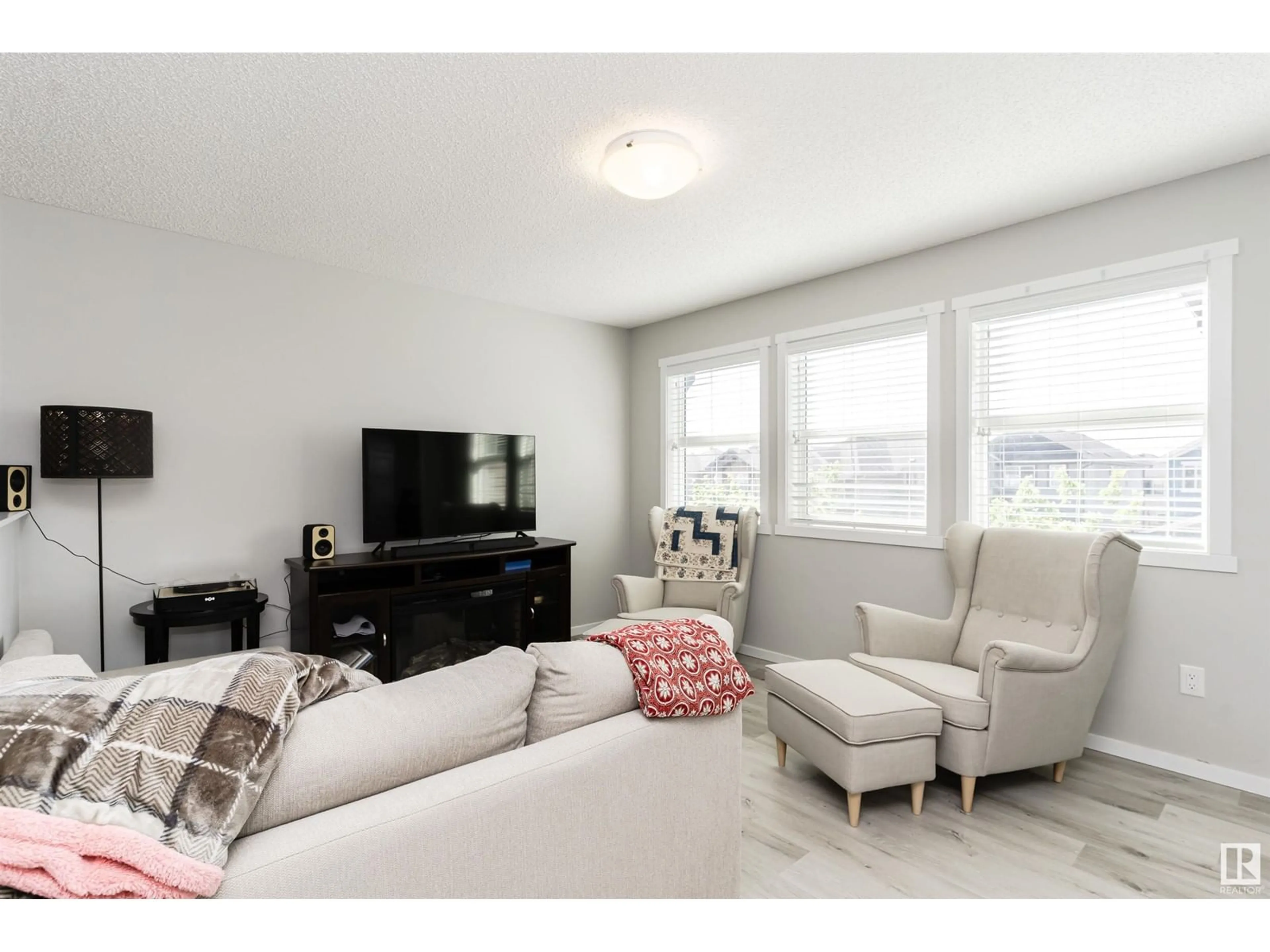 Living room with furniture, wood/laminate floor for 4214 171A AV, Edmonton Alberta T5Y0Z7