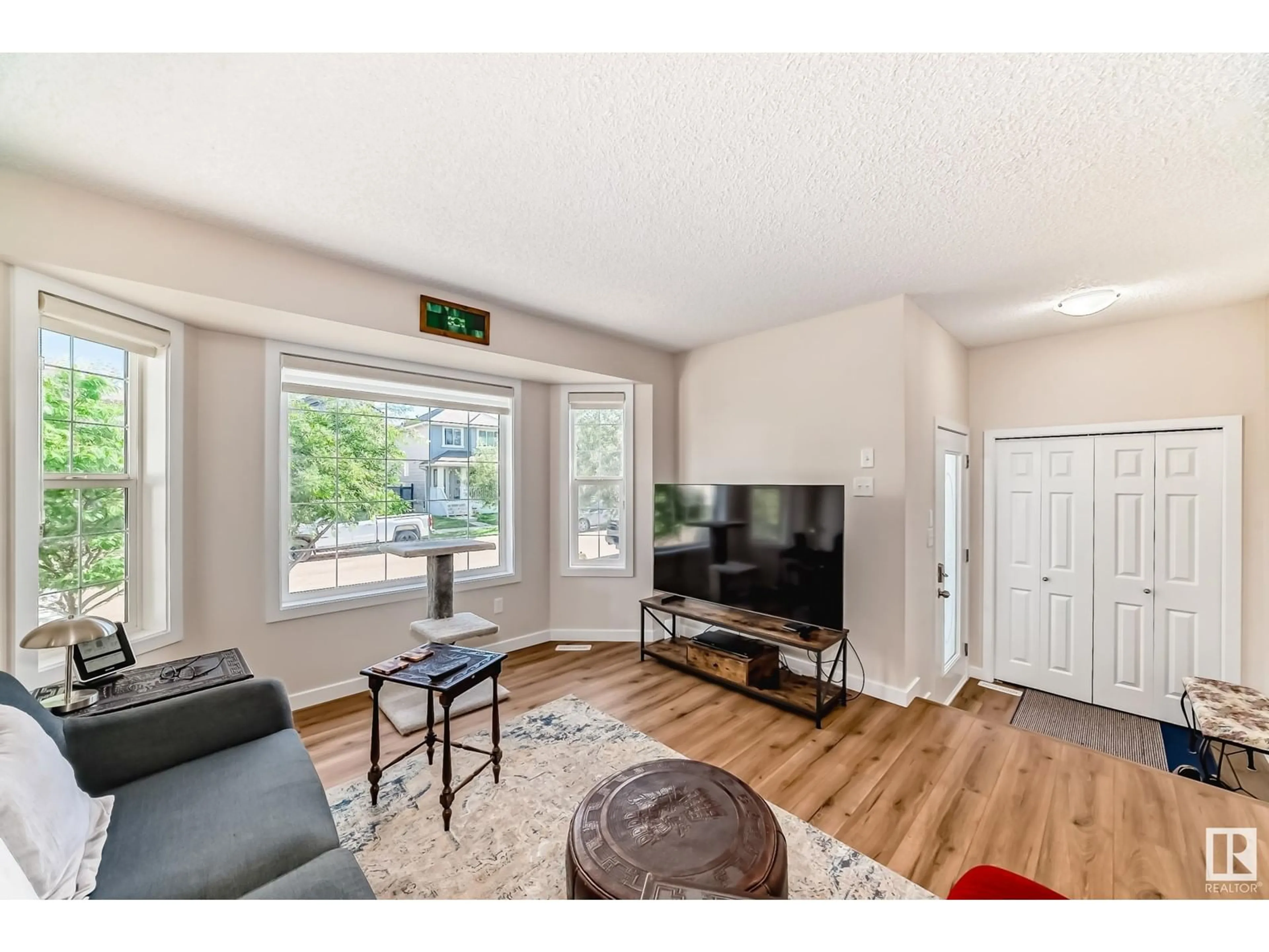 Living room with furniture, wood/laminate floor for 106 KEYSTONE LN, Leduc Alberta T9E0J5