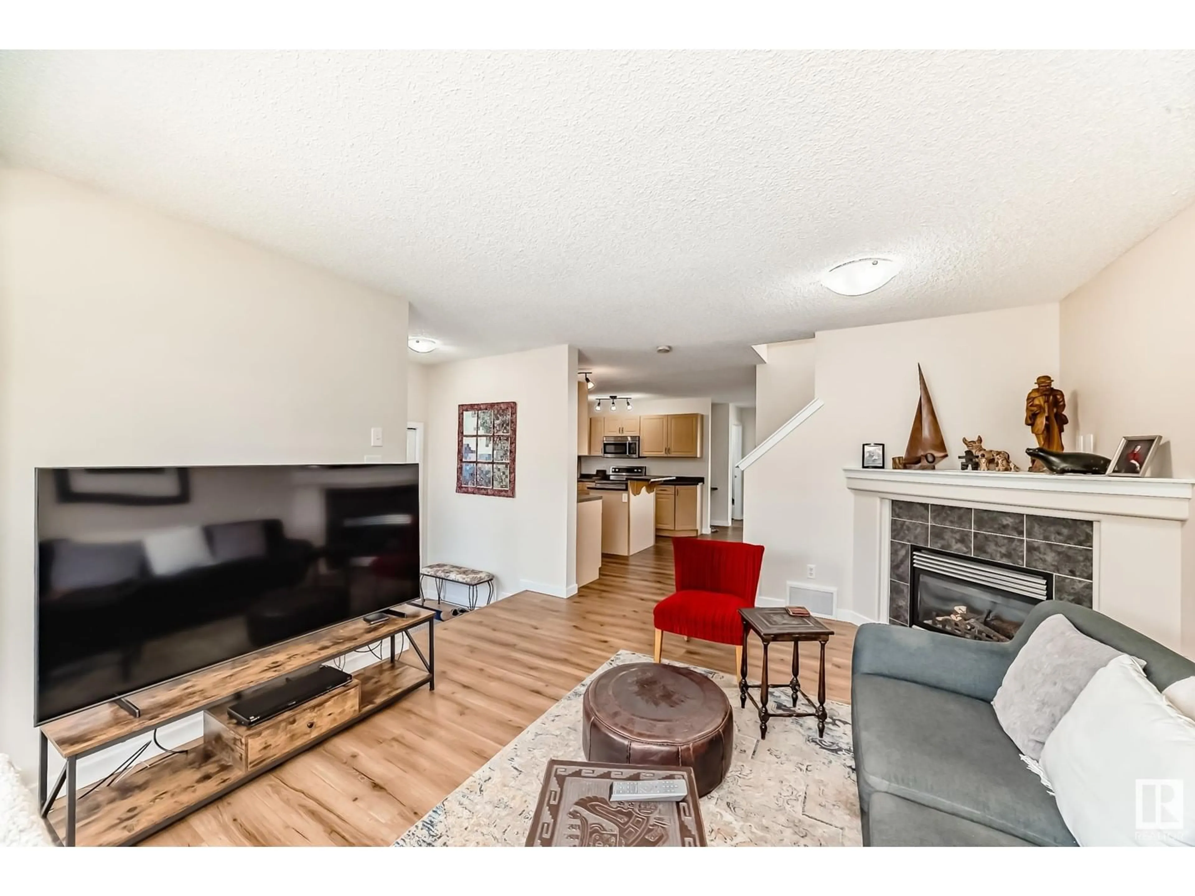 Living room with furniture, wood/laminate floor for 106 KEYSTONE LN, Leduc Alberta T9E0J5