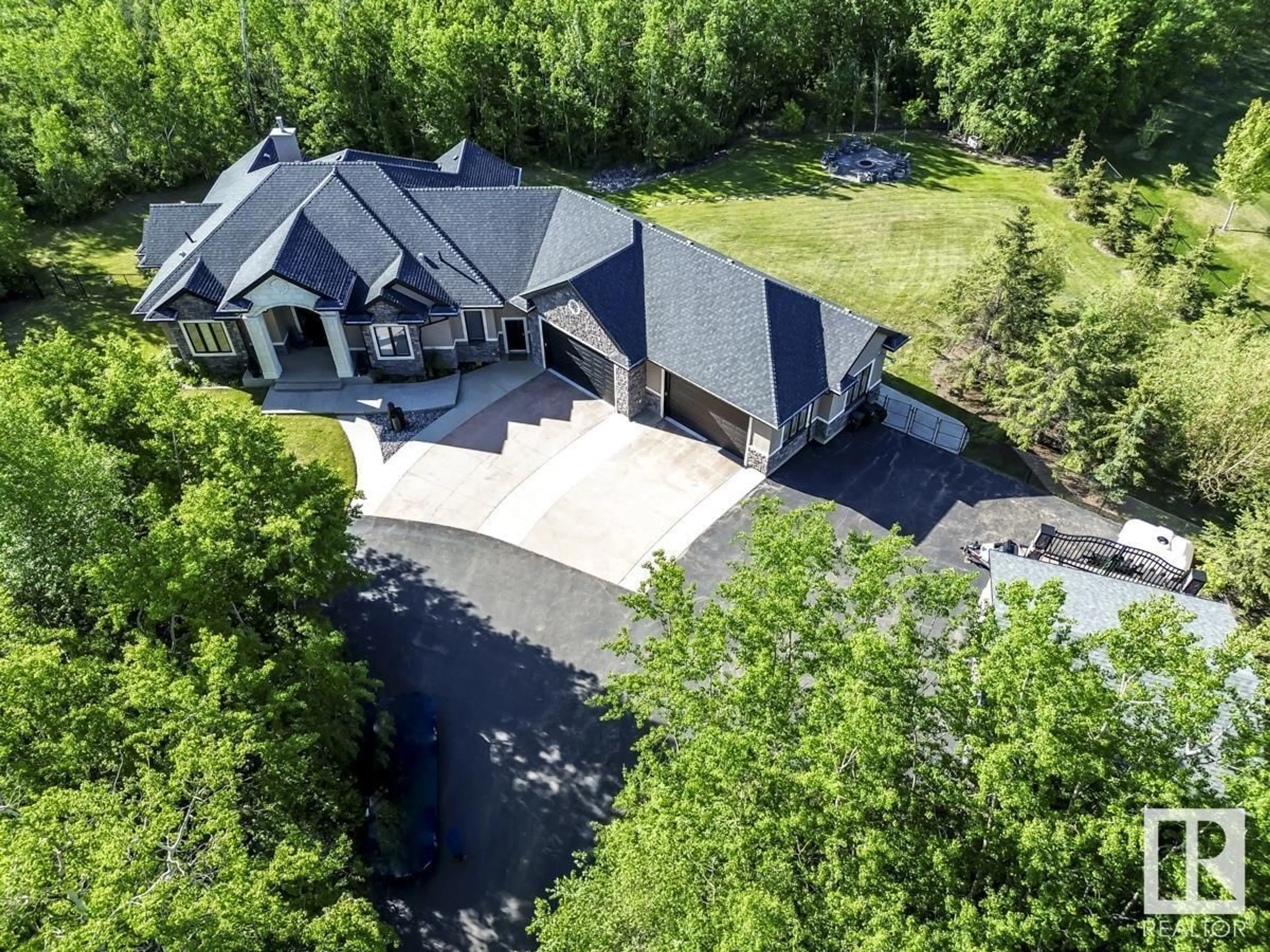 A pic from outside/outdoor area/front of a property/back of a property/a pic from drone, mountain view for 217 - 52105 RGE ROAD 225, Rural Strathcona County Alberta T8C1C2